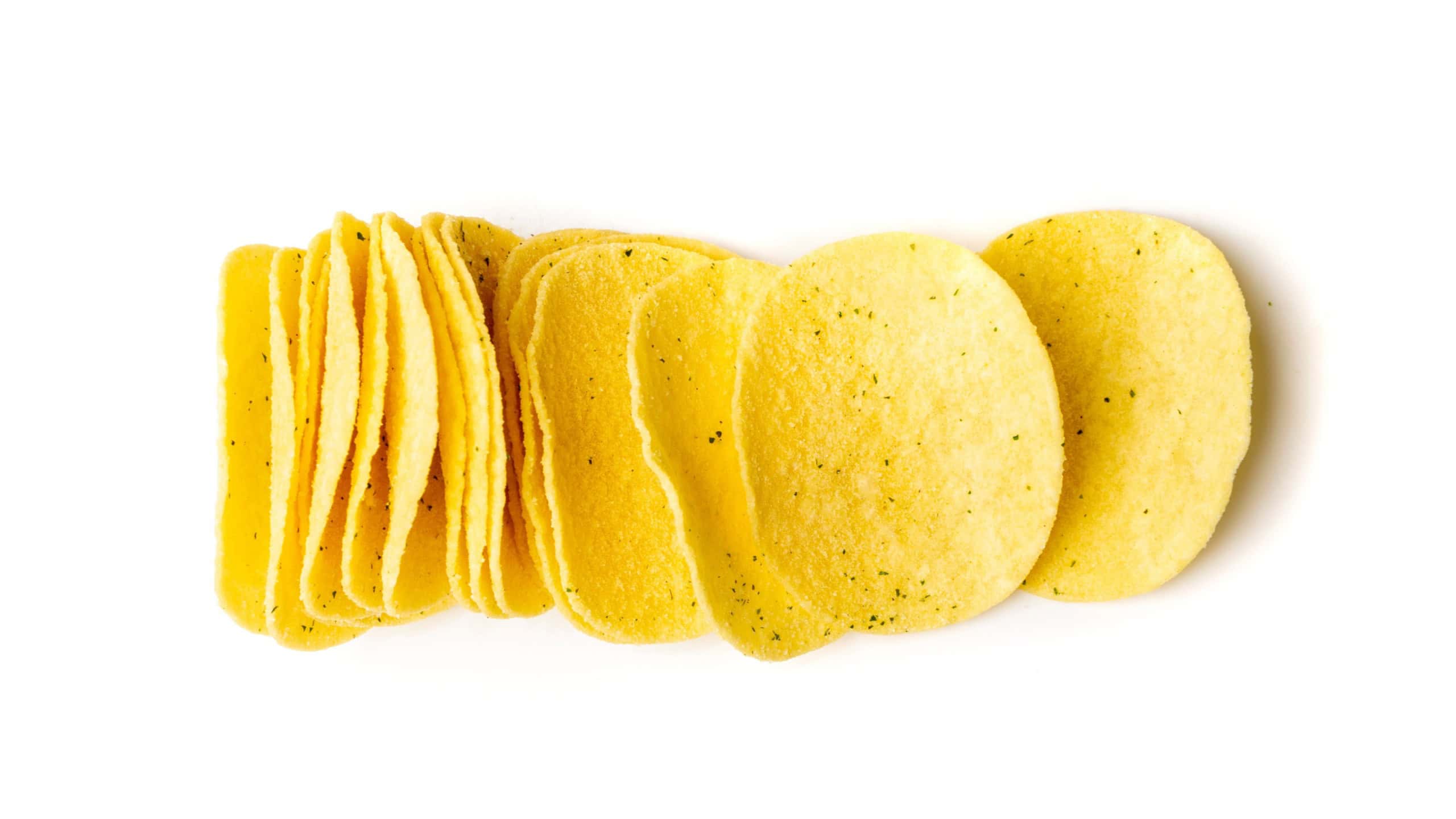 Potato chips stack isolated. Crispy thin potato snack pile, fast food snacks on white background top view