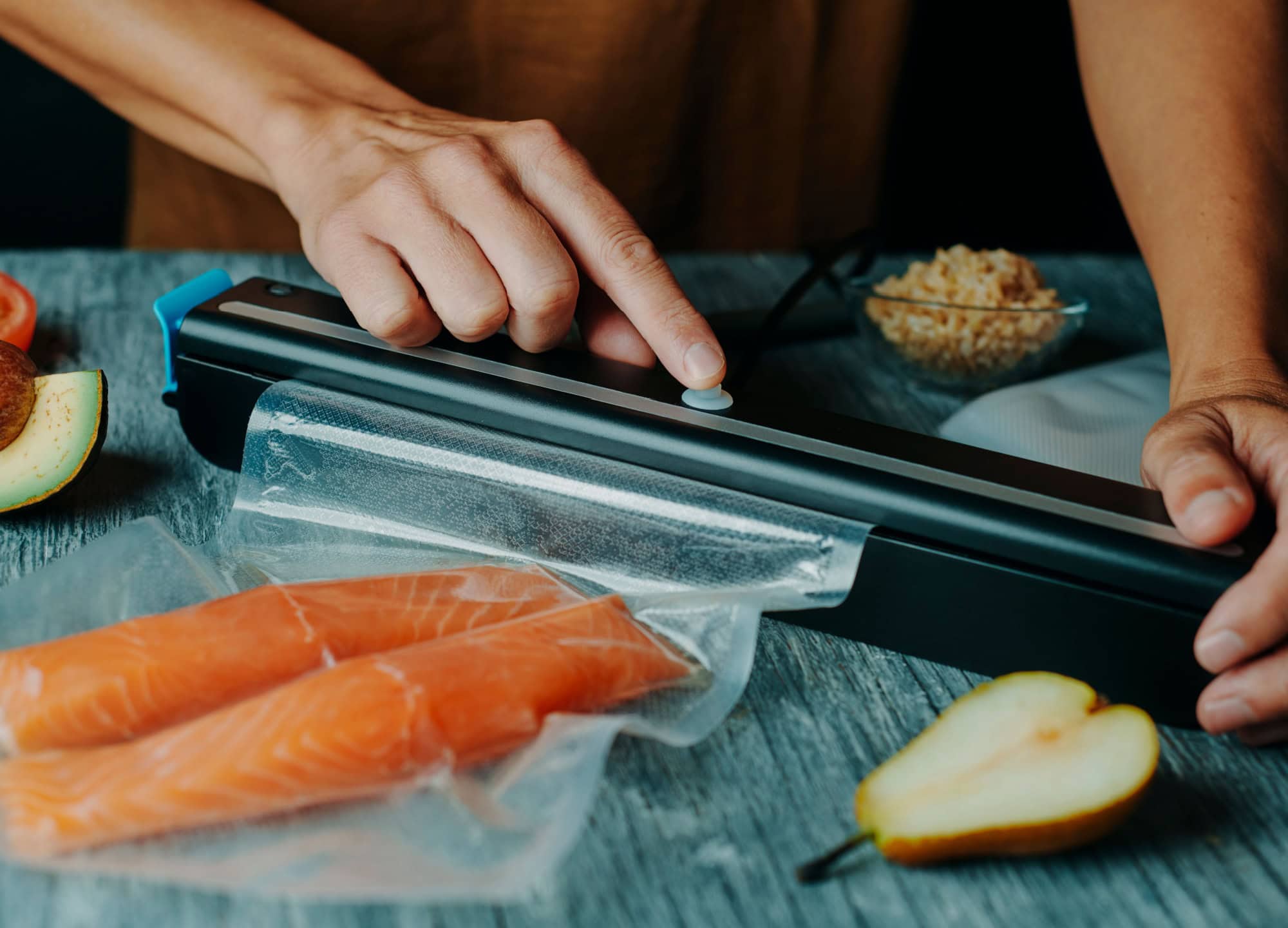 Zesting and juicing fresh lemon on a white cutting board.
