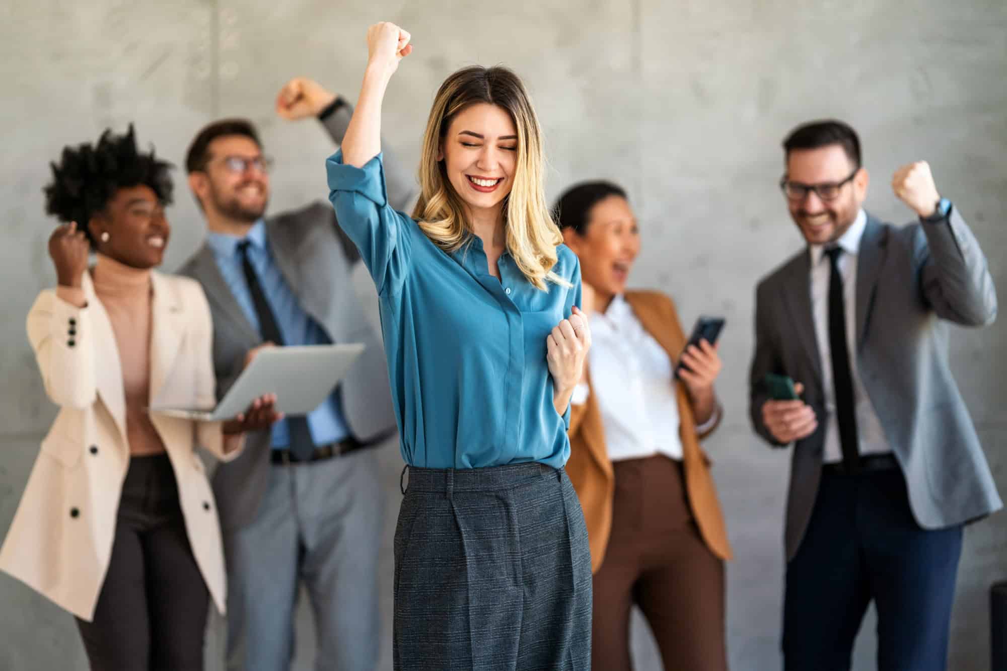 Excited overjoyed diverse business people, team celebrate corporate victory together in office