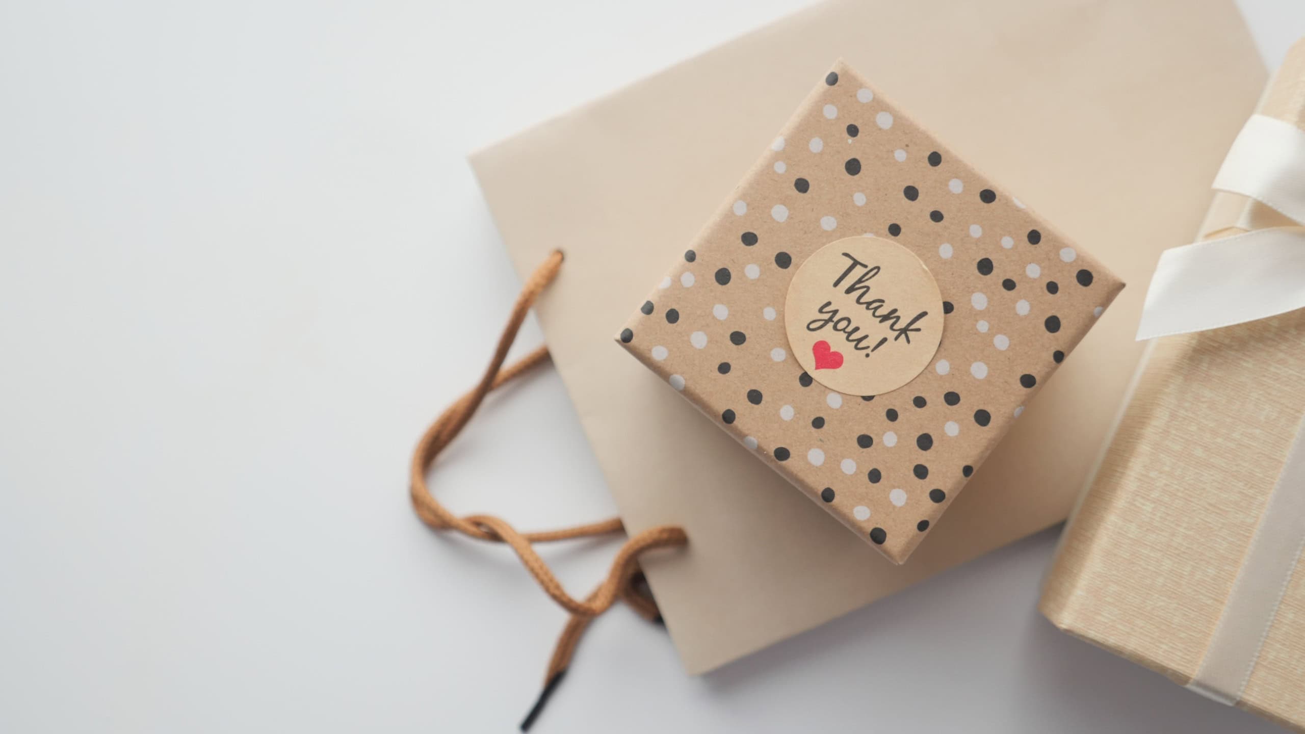 a thank you sticker on a gift box on table with copy space