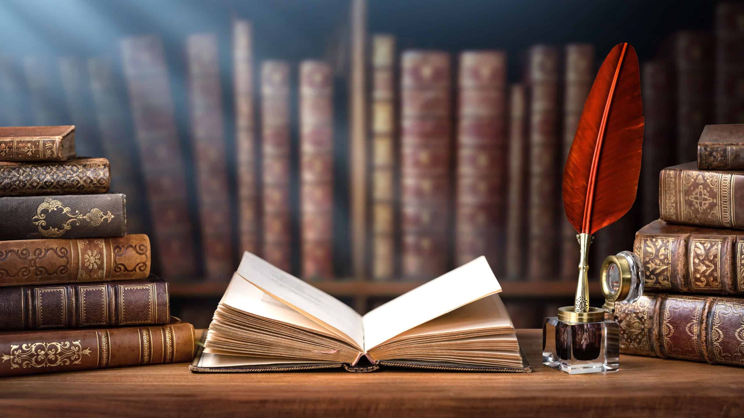 Old books ,quill pen and vintage inkwell in old library. Conceptual background on history, education, ancient, literature topics. Old Books are symbol of knowledge. Retro style.