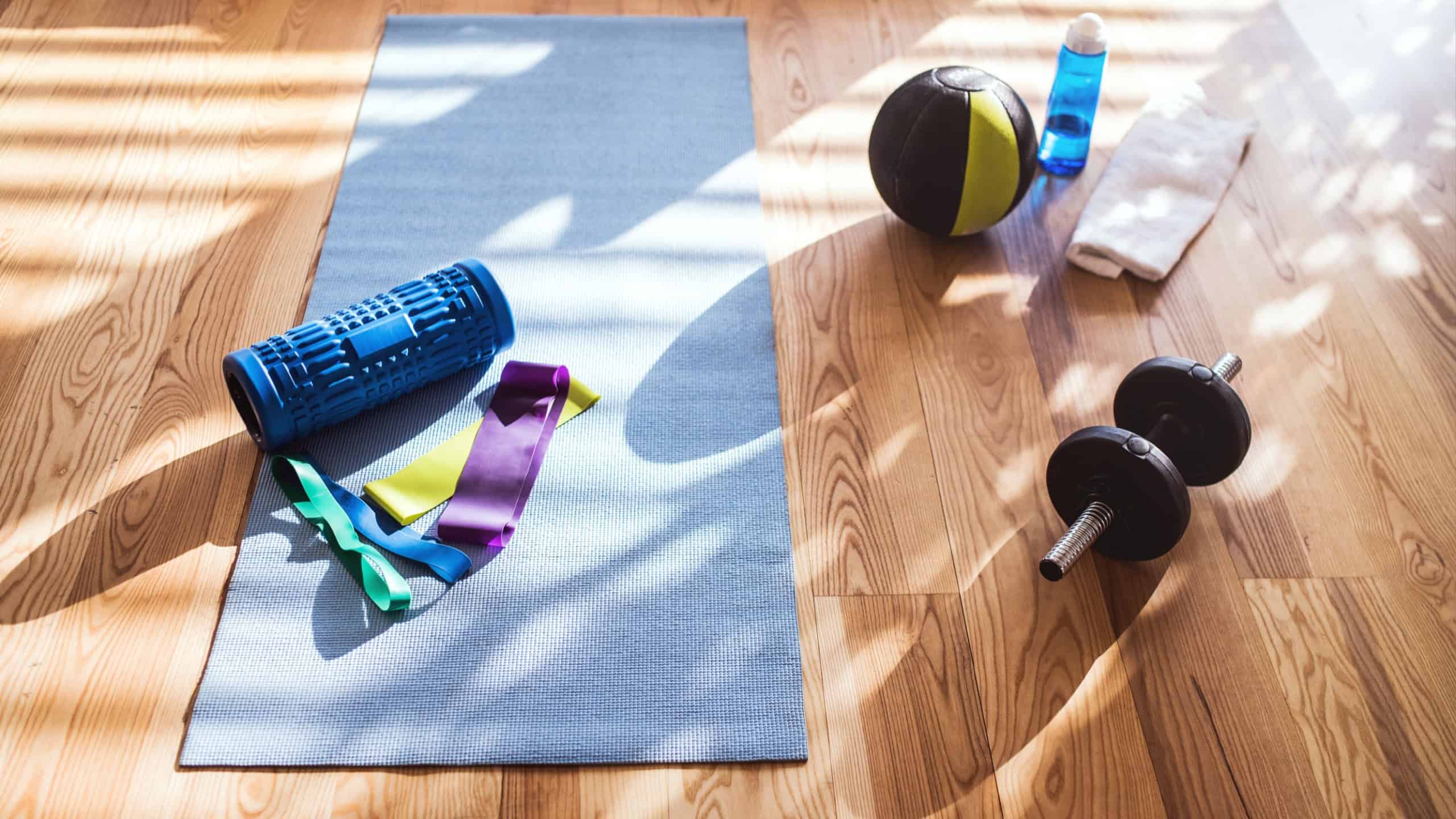 High angle view of fitness equipment on wooden floor. Workout at home.
