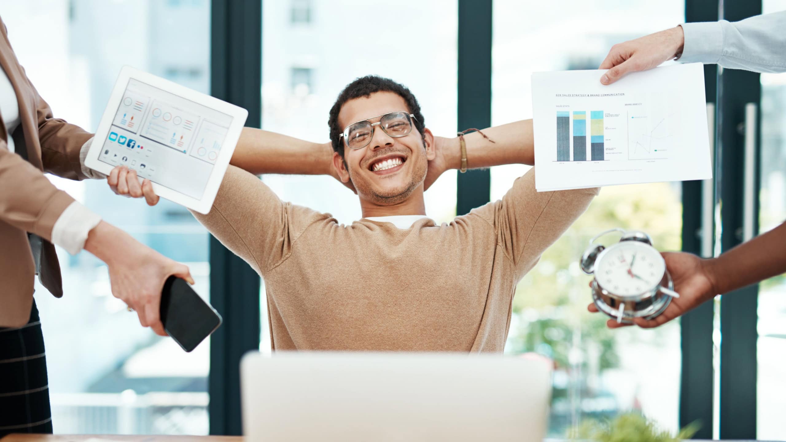 Happy man, multitasking and group with hands, office or portrait for charts, laptop and smartphone. Person, smile and time management with calm, relax or tablet for progress report at creative agency