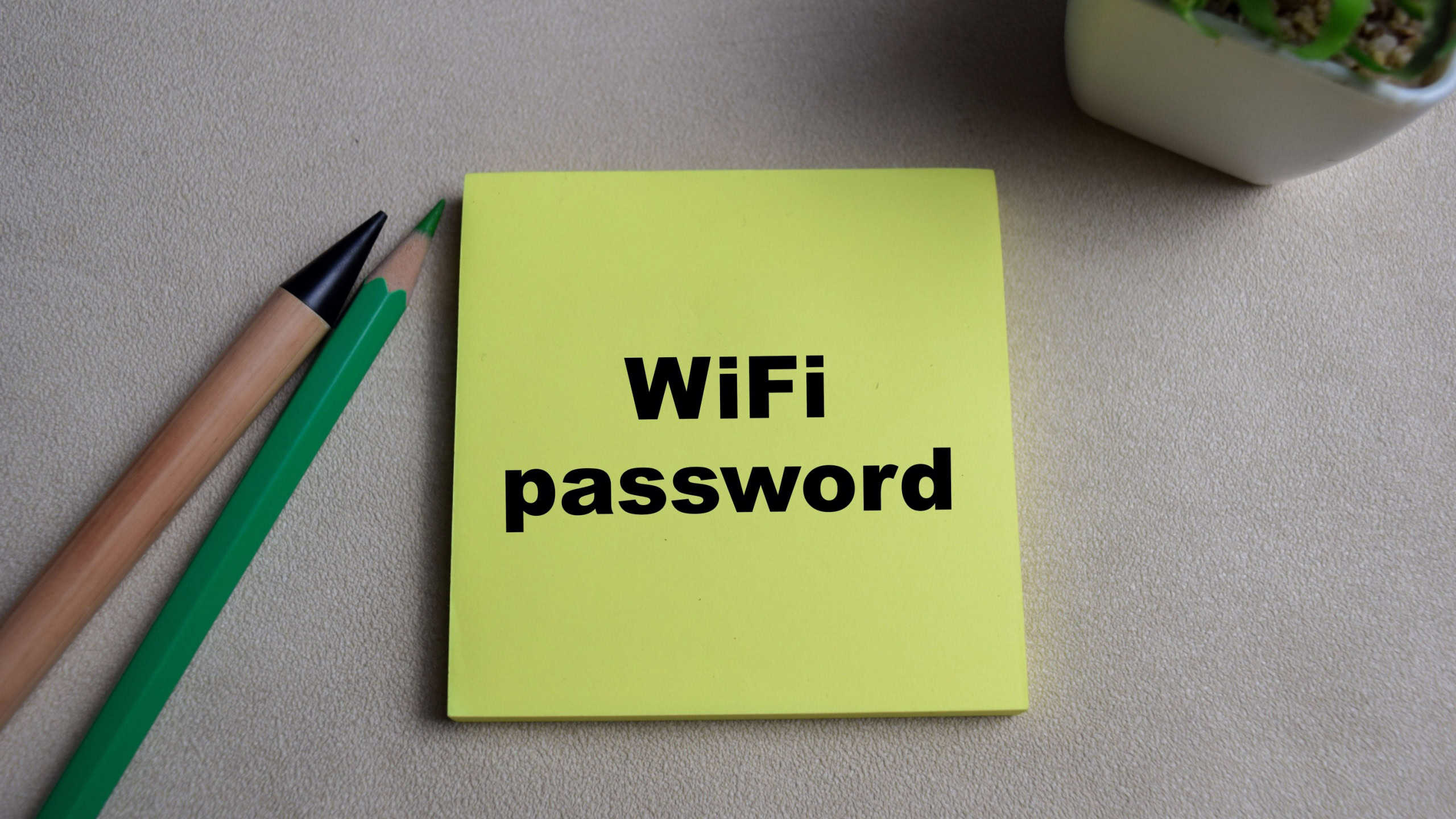 Concept of Wifi Password write on sticky notes isolated on Wooden Table.