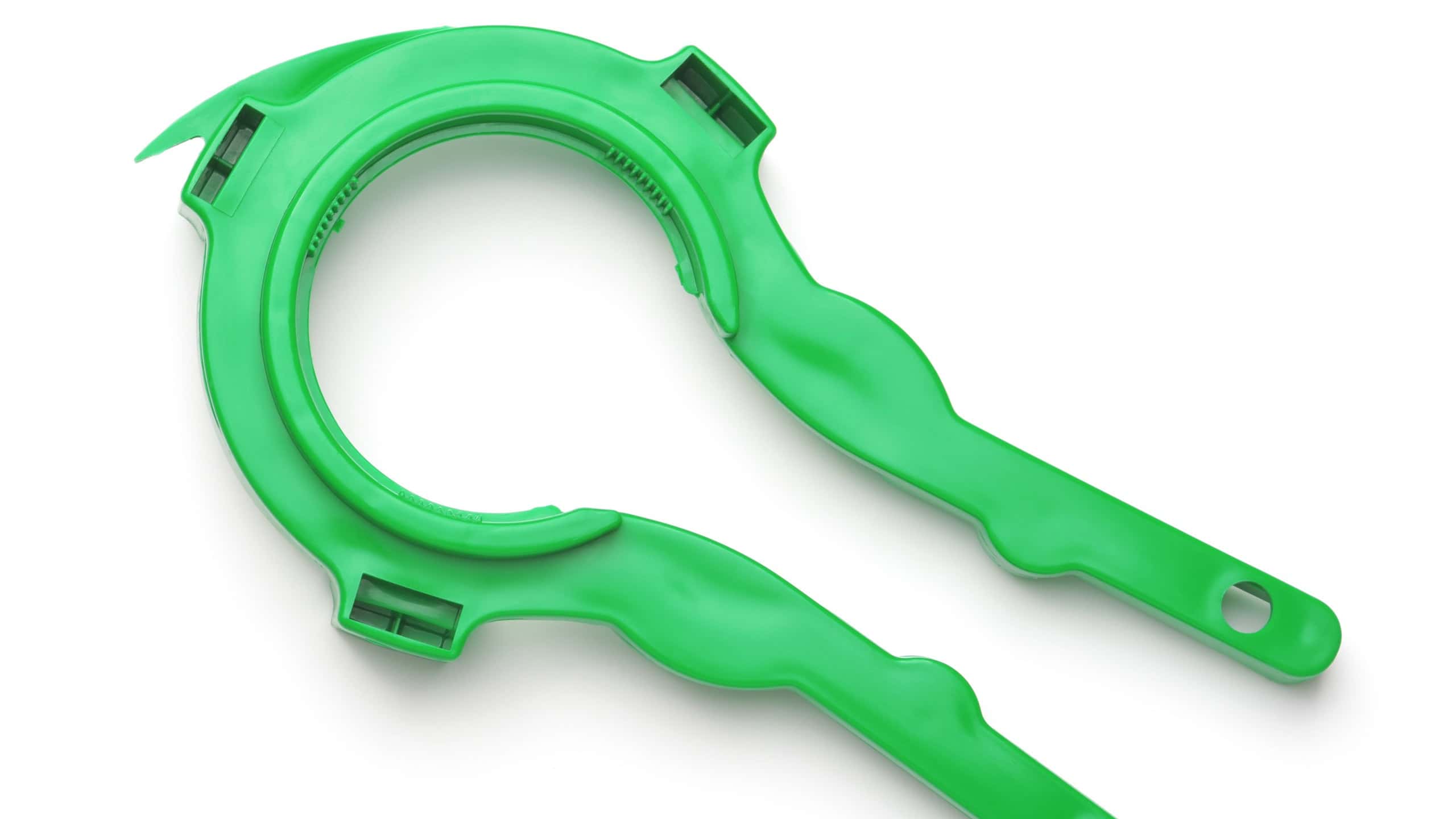 Top view of green plastic jar lid opener isolated on white