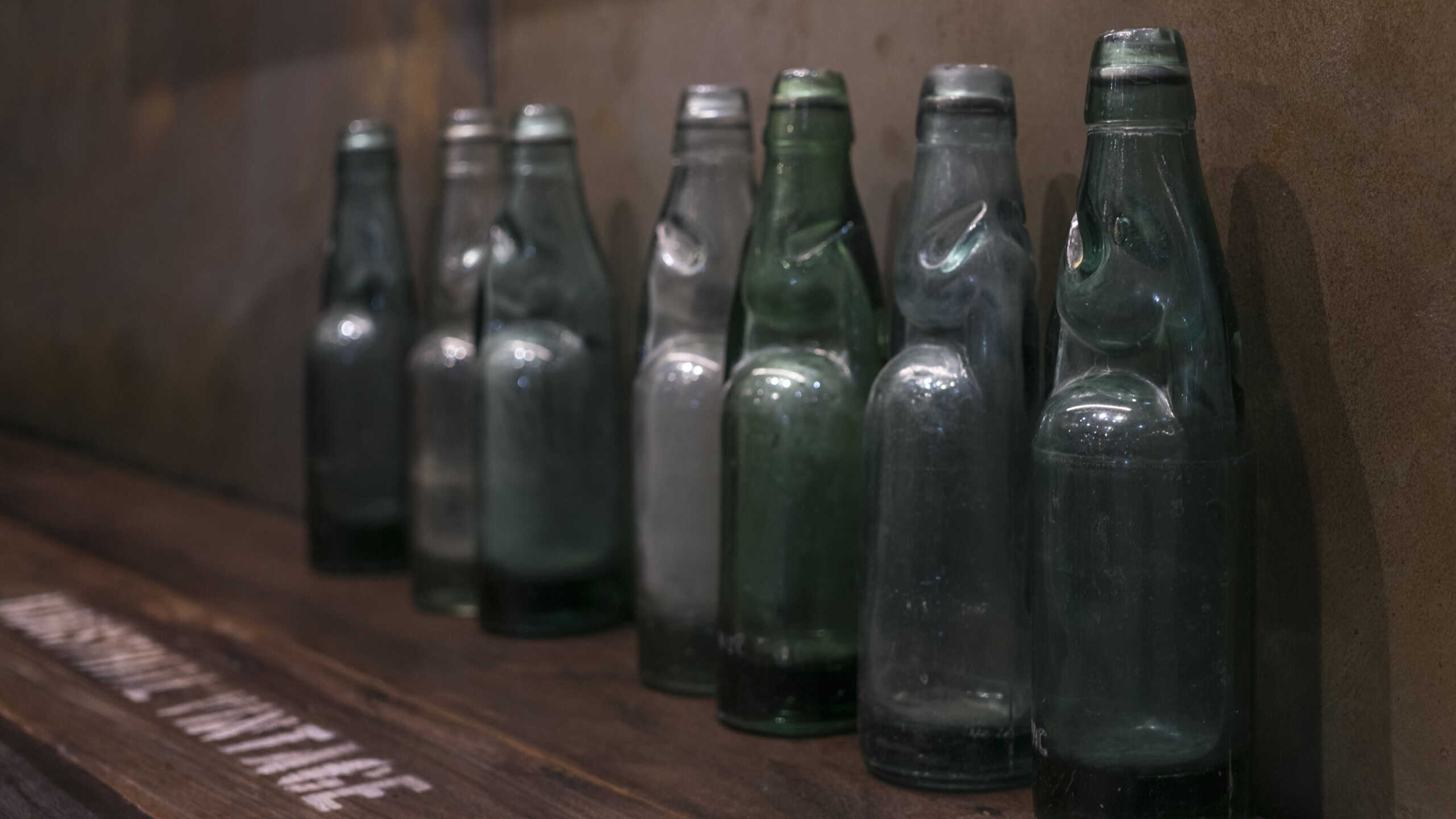 Old vintage bottles on the shelf decorated in the house for vintage retro decoration style.