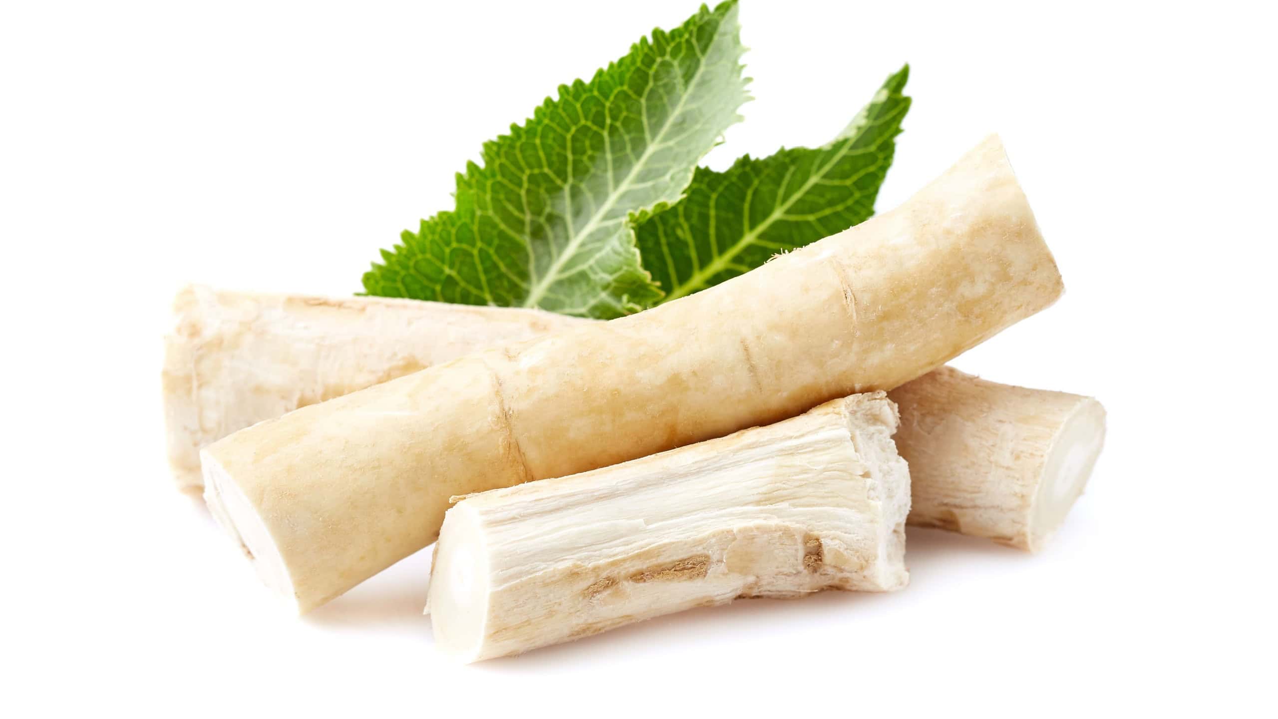 Horseradish root with leaves on white background