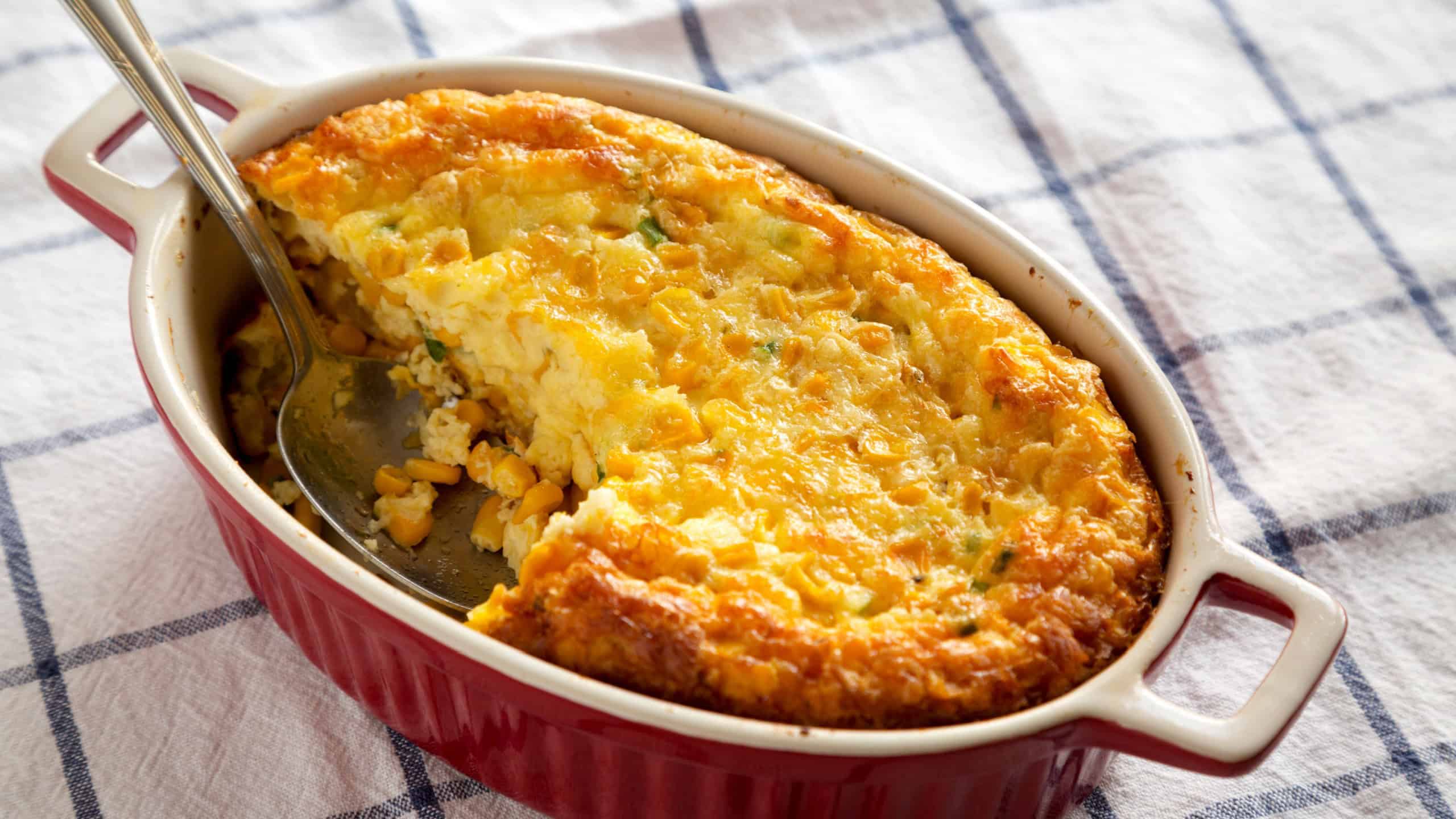 Homemade Cheddar Corn Pudding Casserole, low angle view.