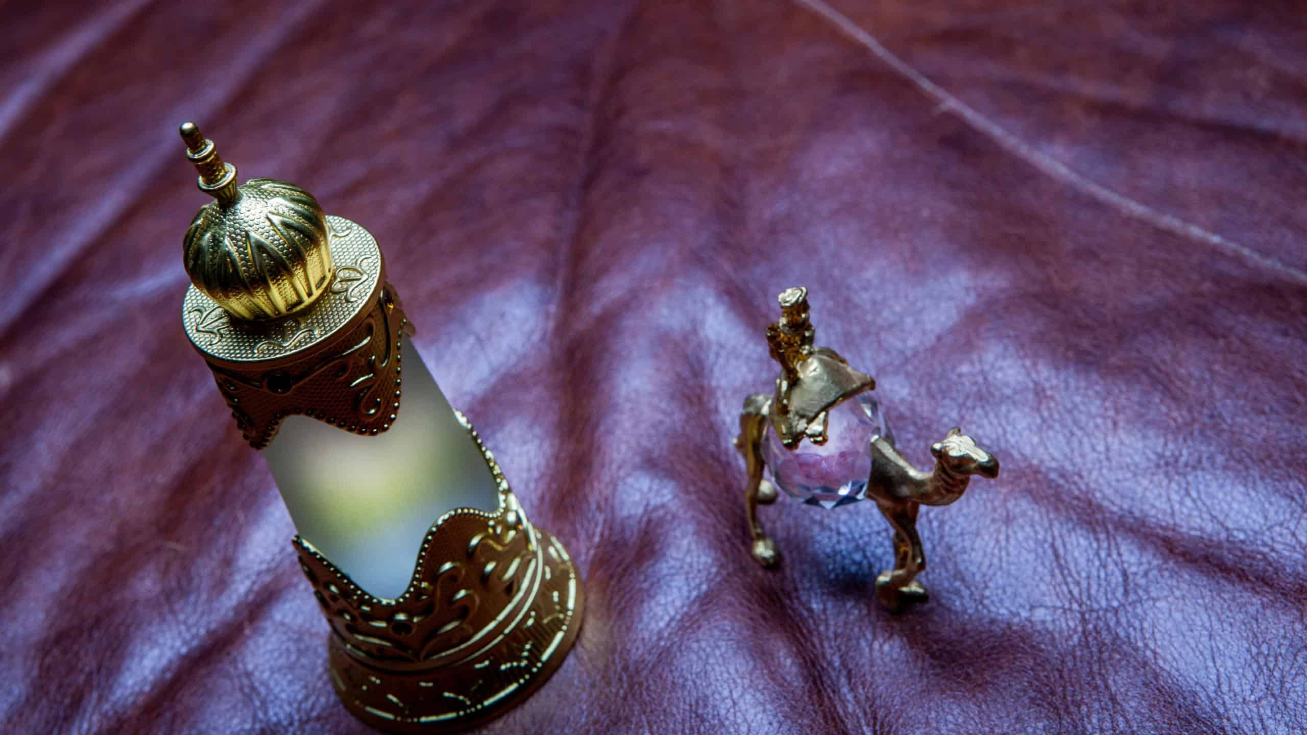 glass perfume bottle camel leather background