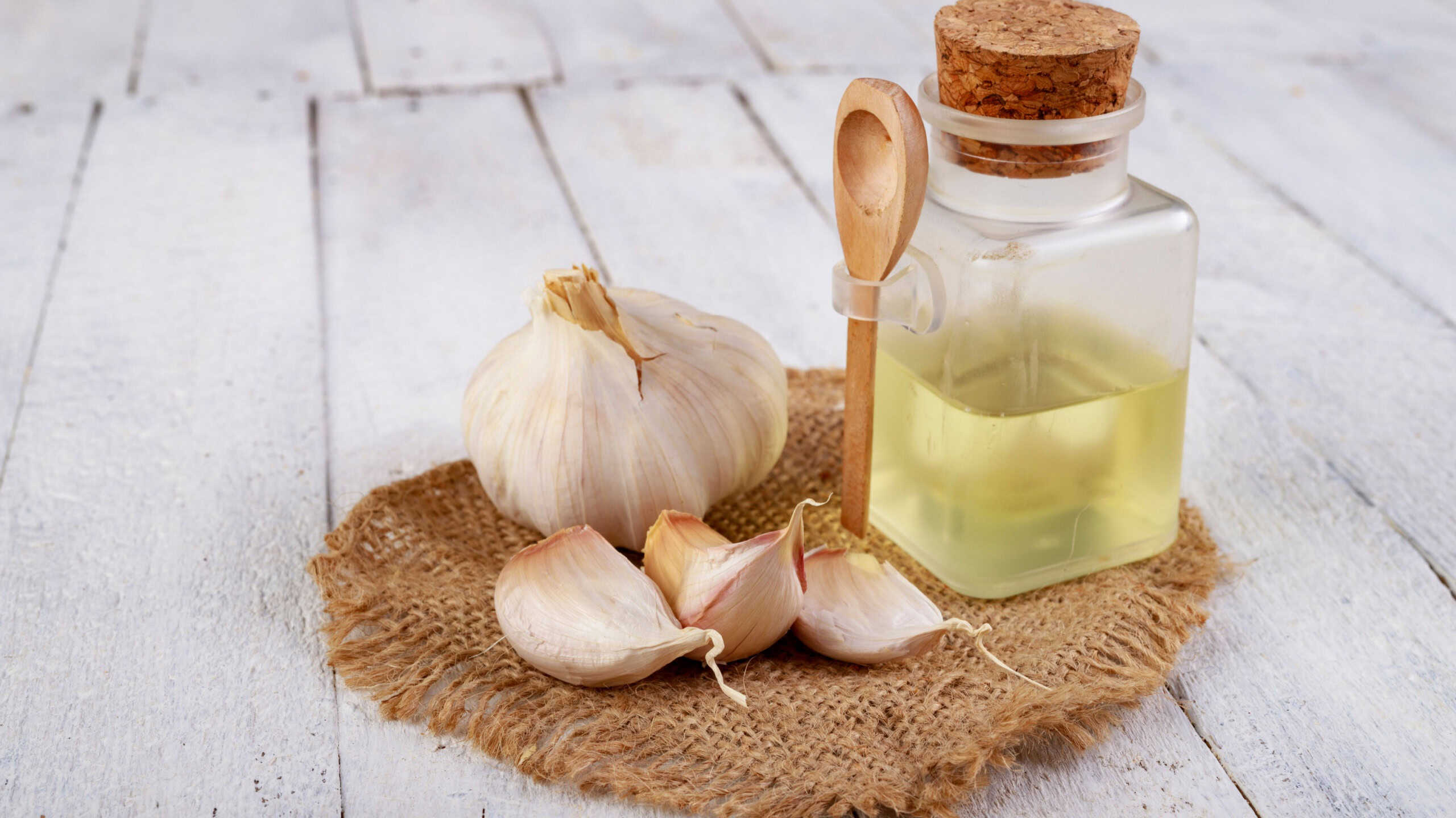 Fresh garlic and squeezed flu juice. Home remedies to cure infections and colds. Light background.