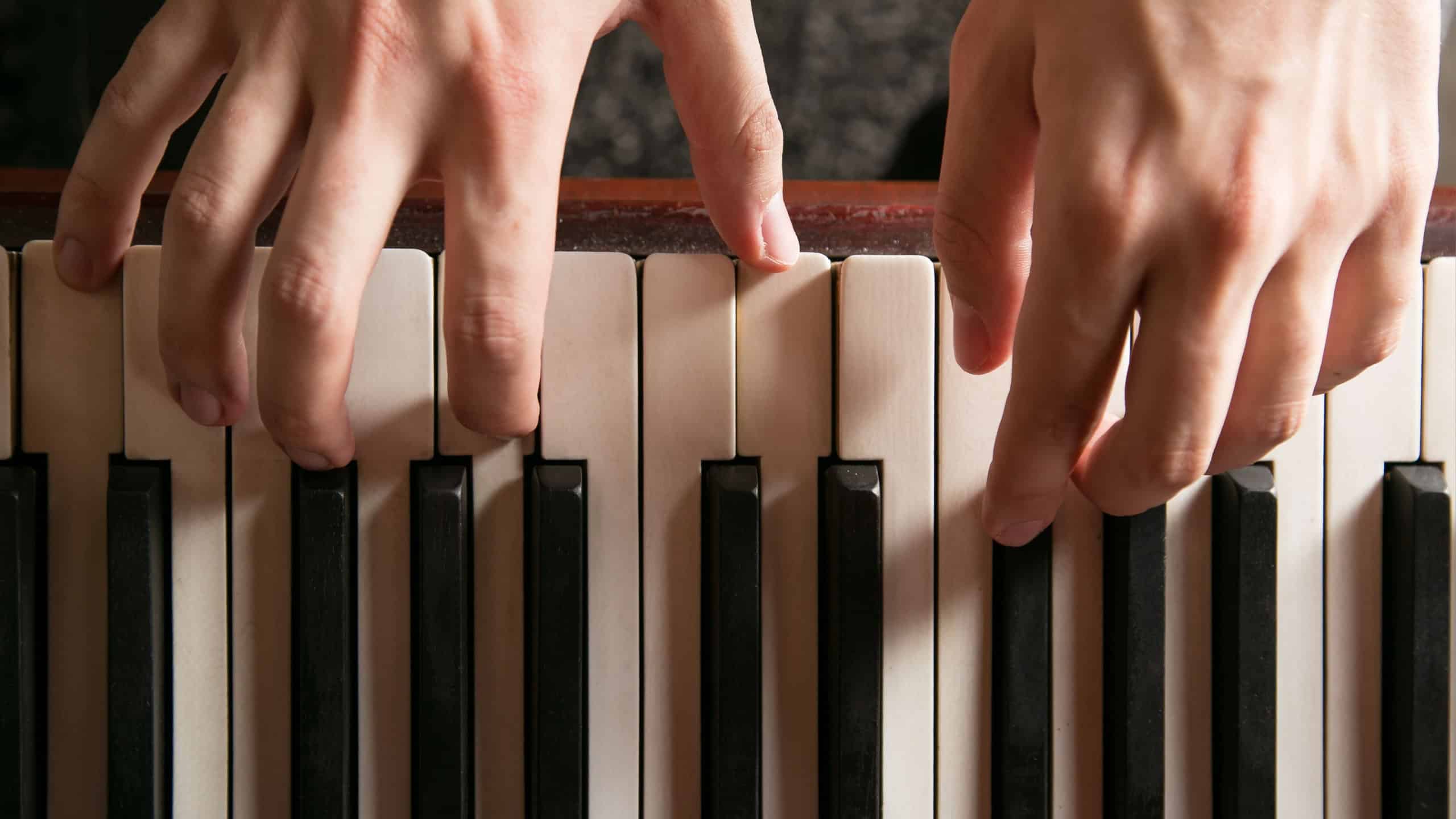 Close-up of hands playing the piano