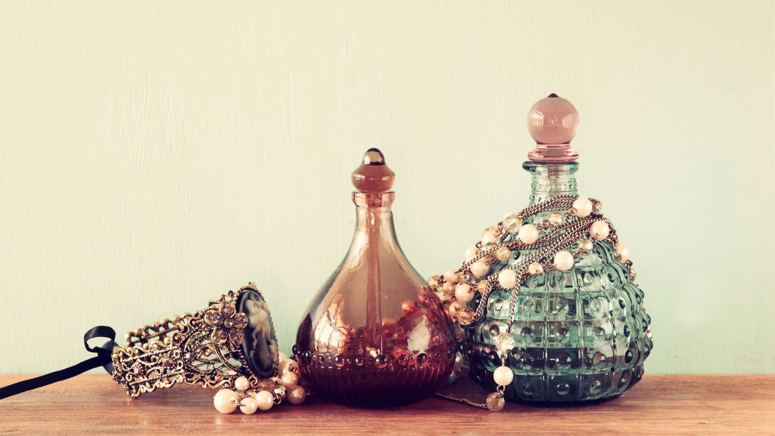 vintage antique perfume bottles, on wooden table. retro filtered image
