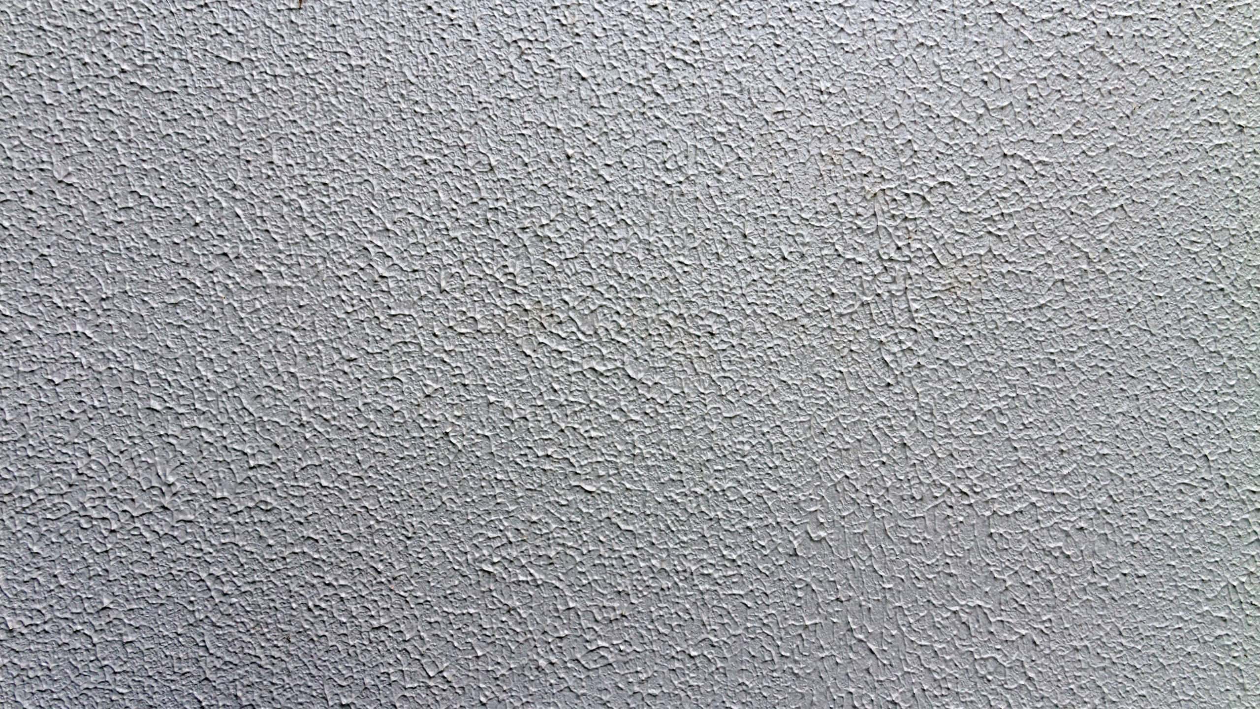 A closeup shot of a white popcorn ceiling surface