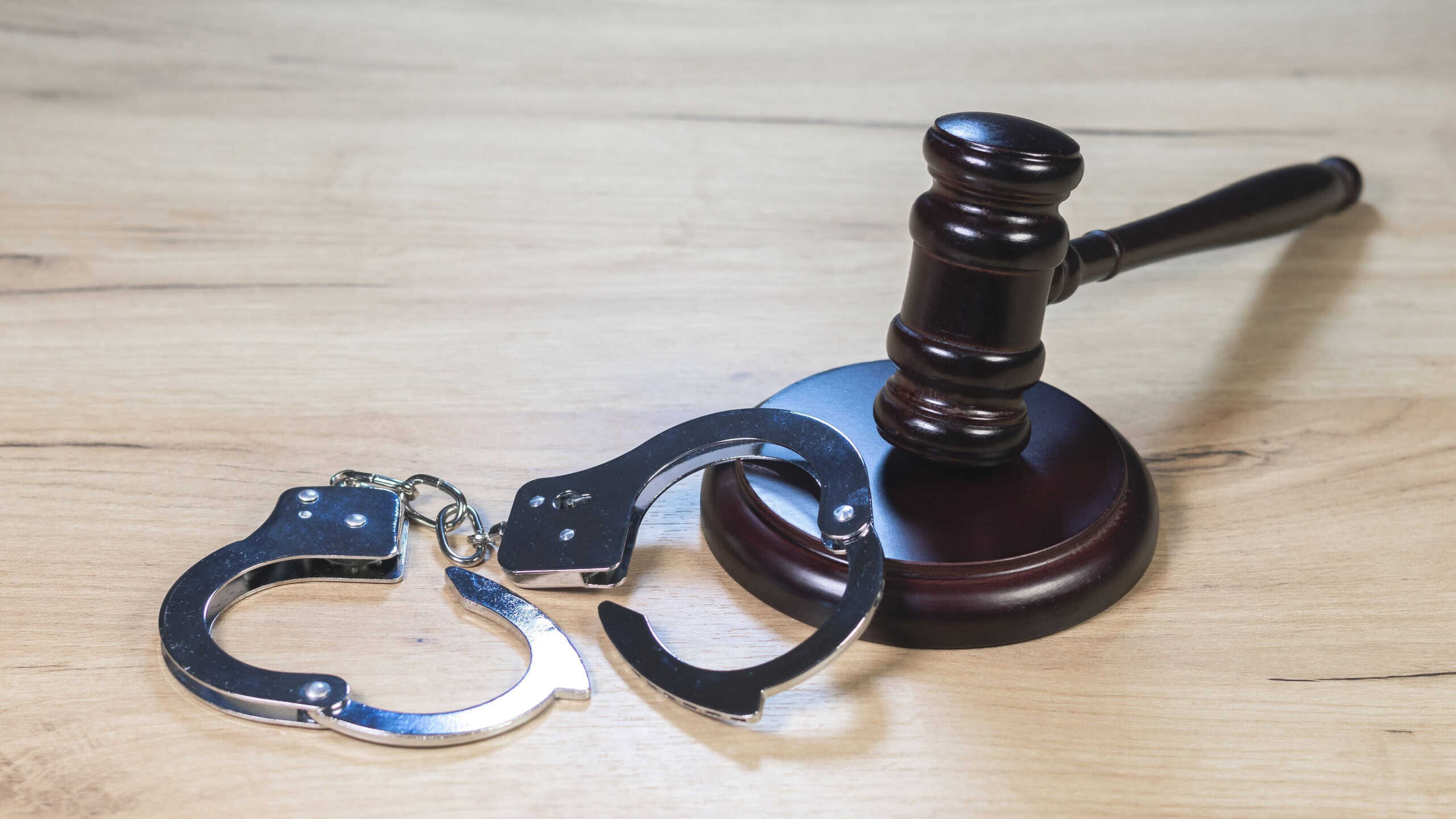 Judge Hammer for adjudication with wooden stand and handcuff. Auction or Lawyer decision. Law and justice concept. Court of law. Pronouncing sentence, striking Gavel.