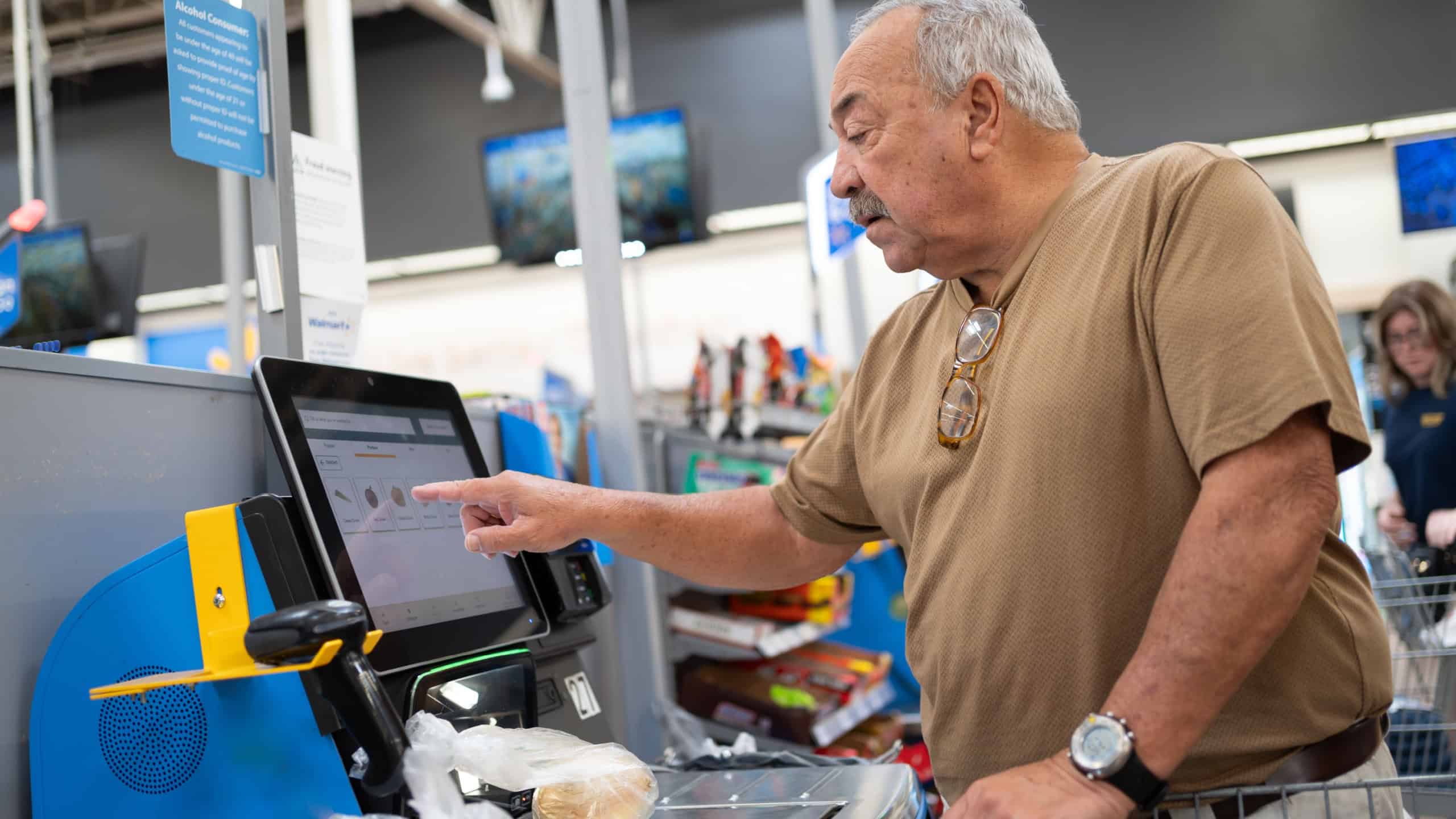 Pembroke Pines Florida, USA - September 13, 2024: Senior man is paying at an electronic checkout in a supermarket.