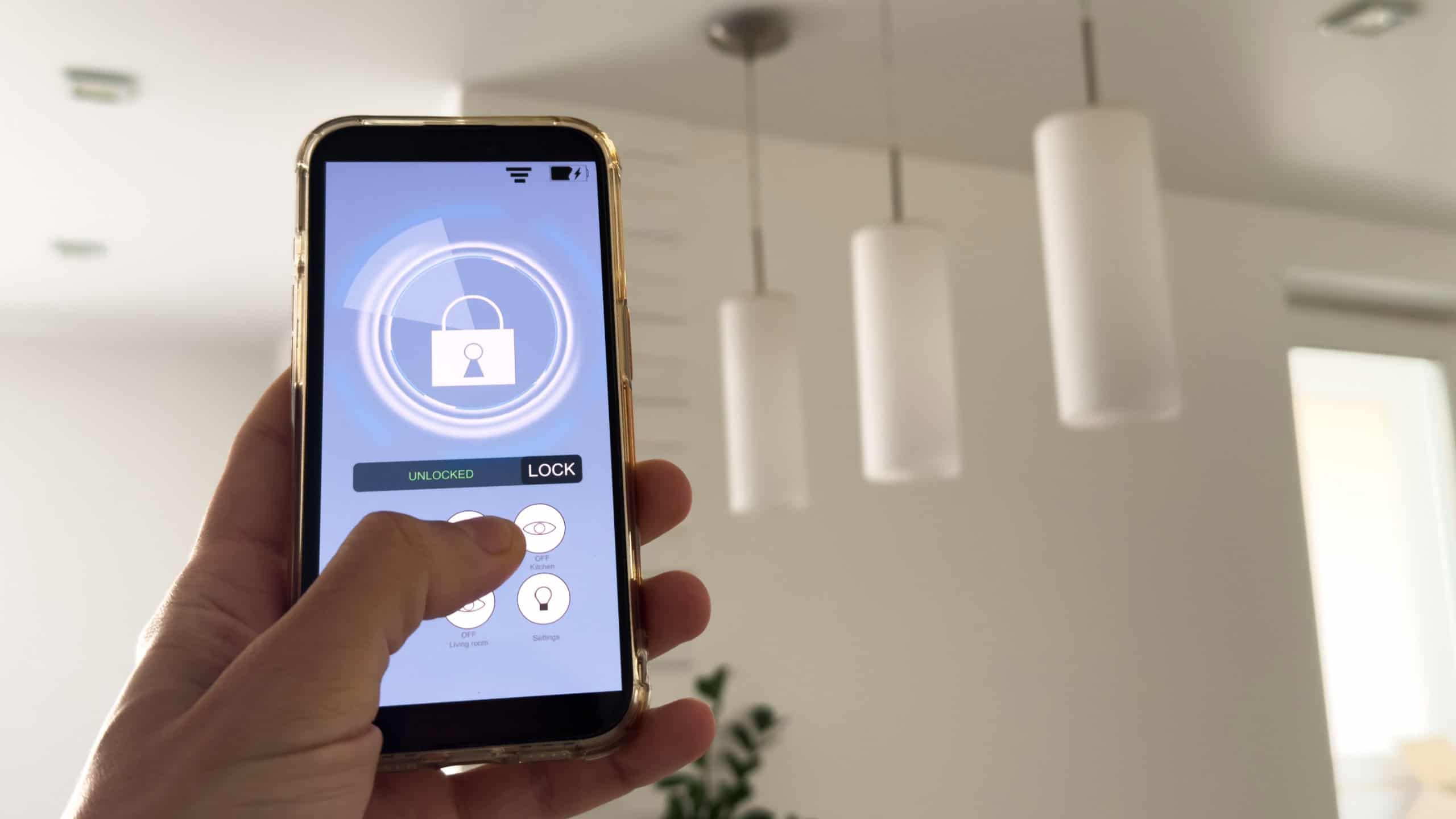 Smart house, home automation, device with App icons. Man uses his smartphone with smarthome app to control the lights of his house.