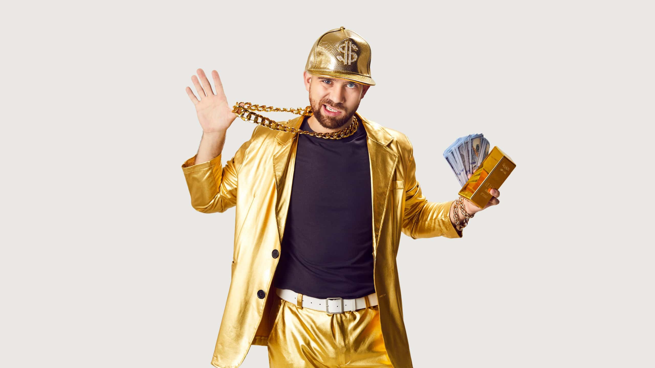 Rich man in a gold suit holds bundles of cash money and a gold bar against a white background. His portrait exudes success, wealth, and a touch of rapper style in the financial world.