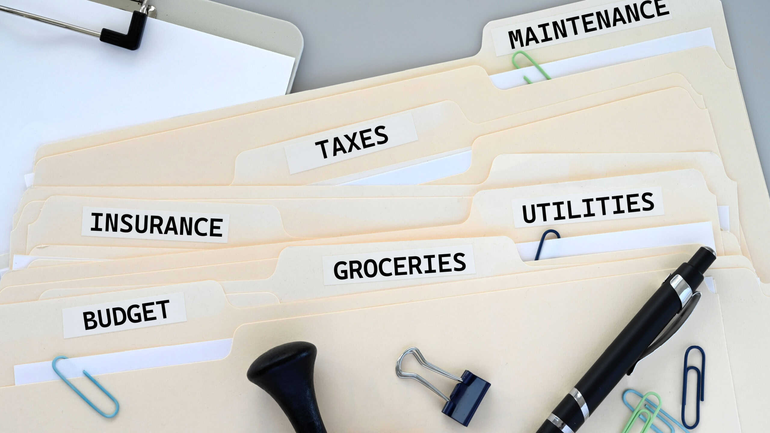 Personal Finance Concept - Budget, groceries, utilities, insurance, taxes, maintenance expenses file folders for records and receipts