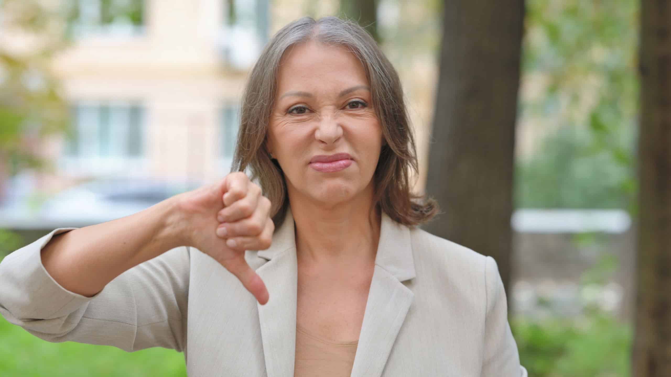 Portrait of Old Woman with Thumbs Down Outdoor