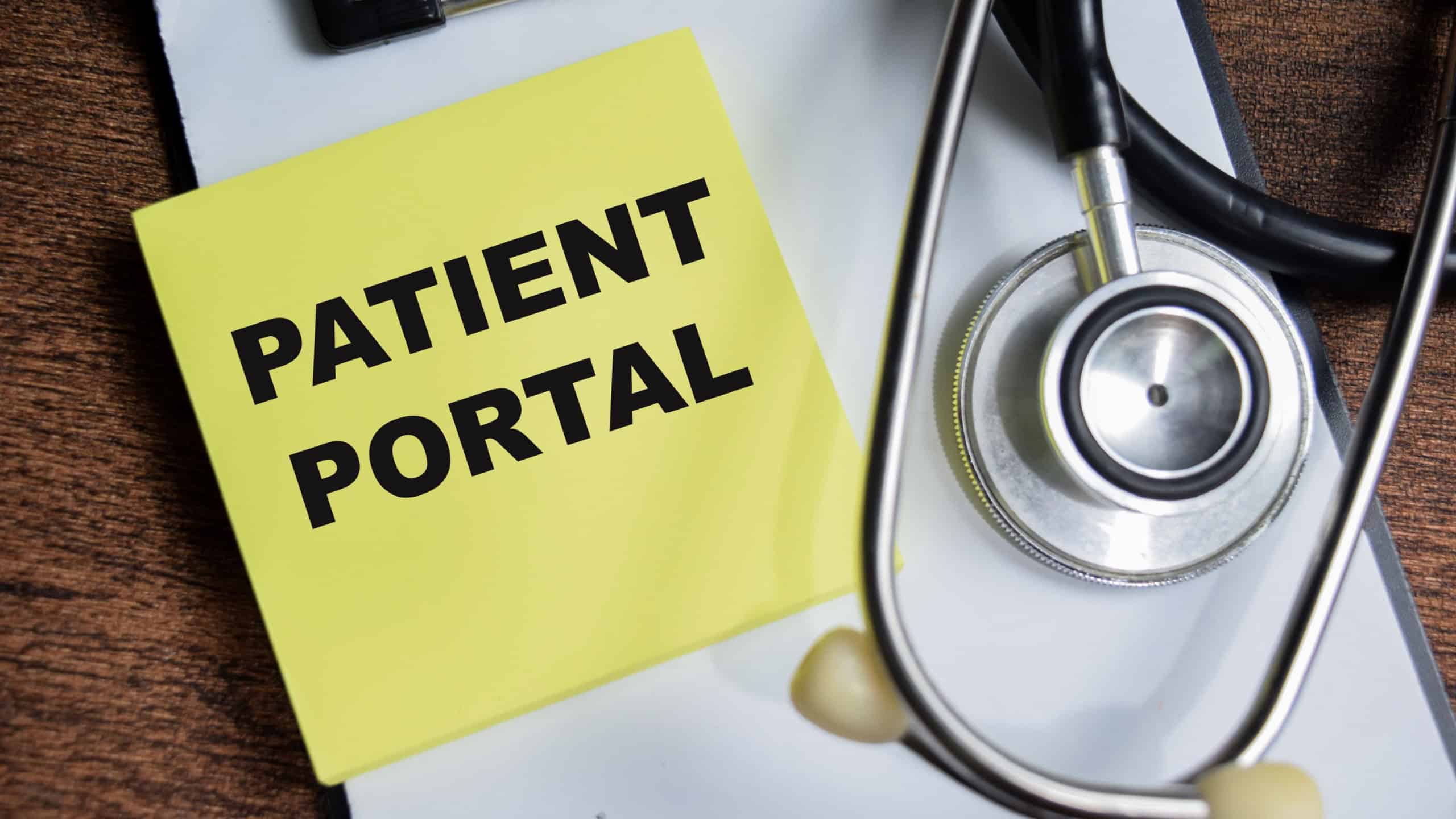 Concept of Patient Portal write on sticky notes isolated on Wooden Table.