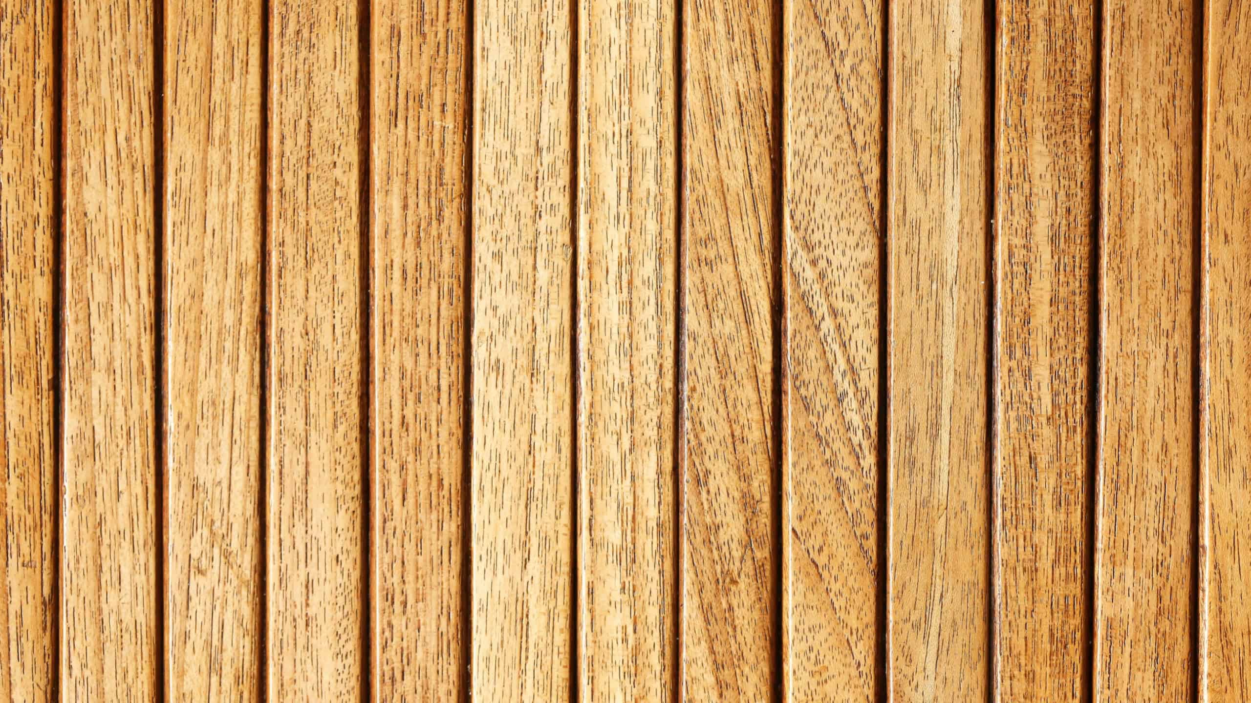 Wooden slatted wall panel. Natural brown wood texture. Vertical planks background. Rustic surface design. Decorative timber pattern. Interior element. Warm color wooden stripes.