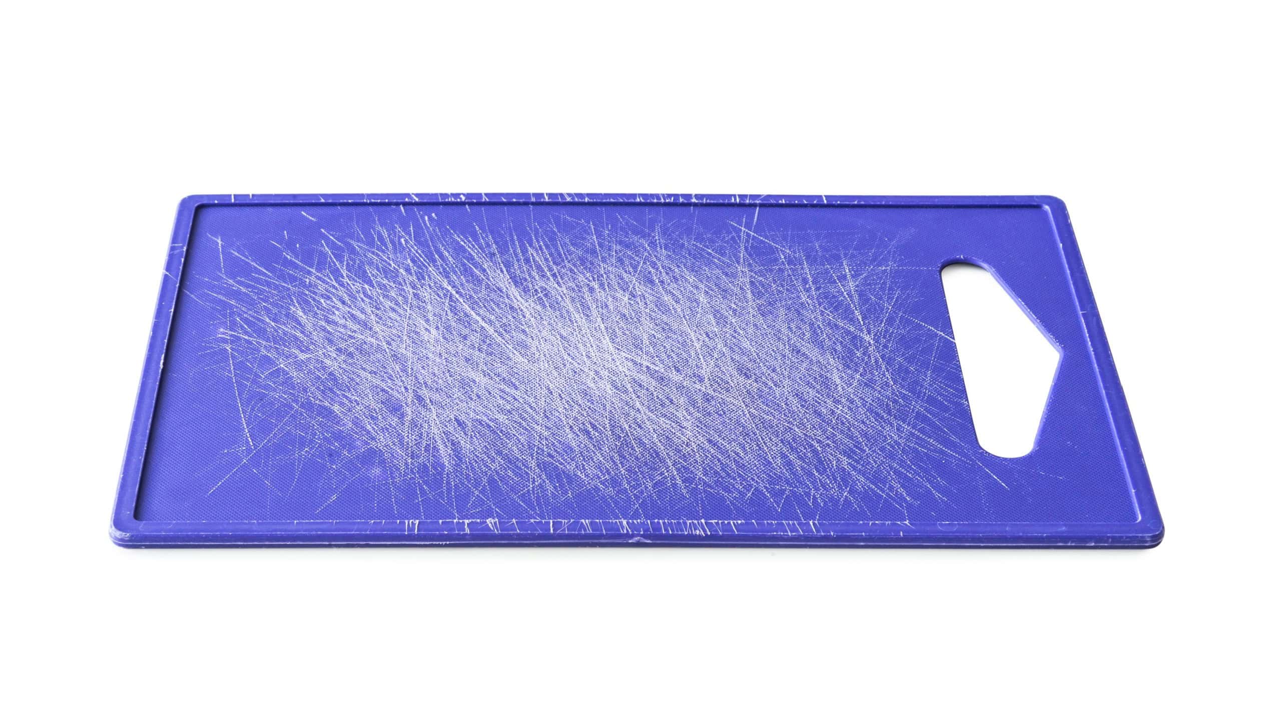 old used plastic cutting board isolated on white background