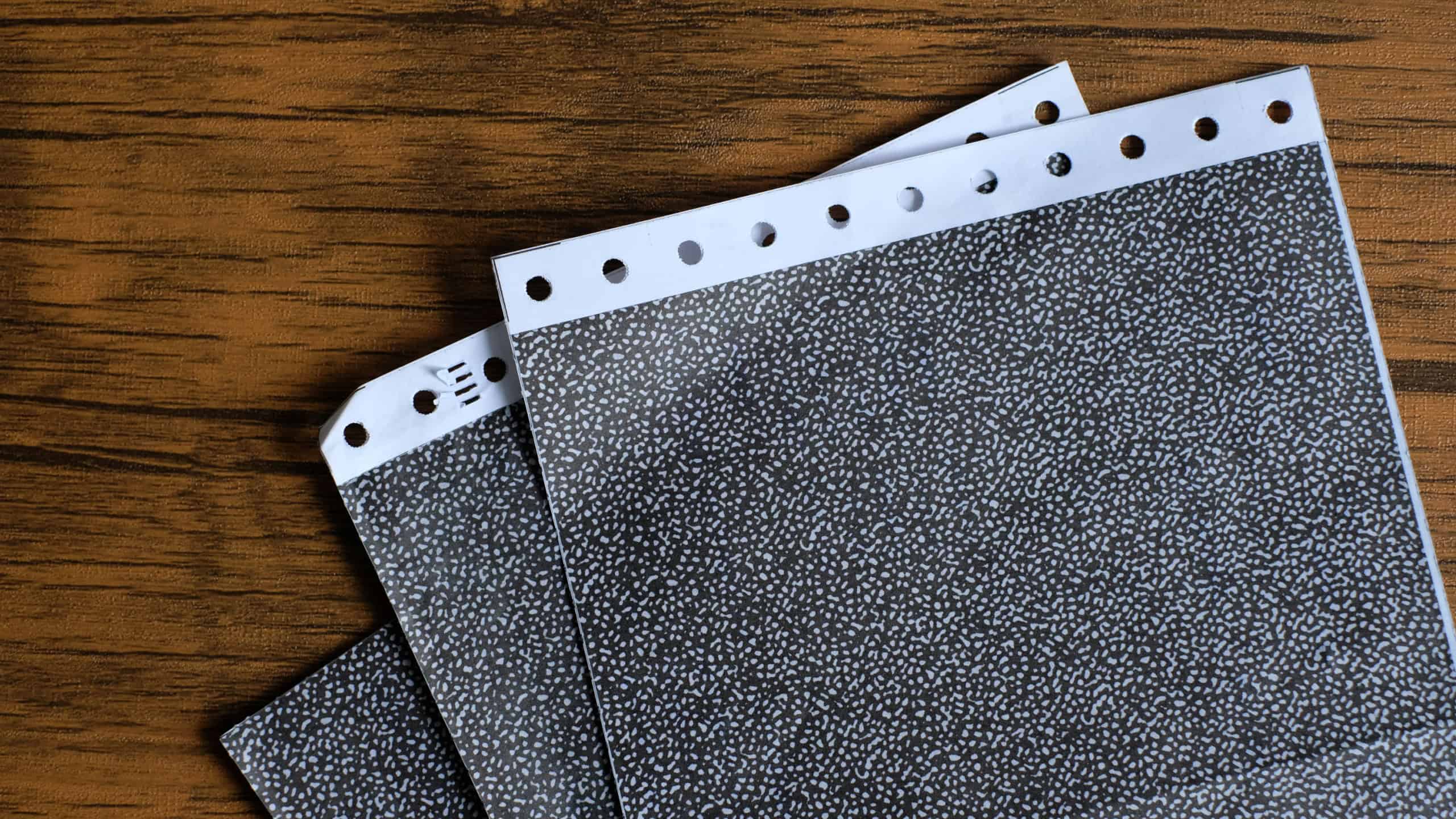 The carbon payslips on wood background. Salary payroll slip.Soft focus.