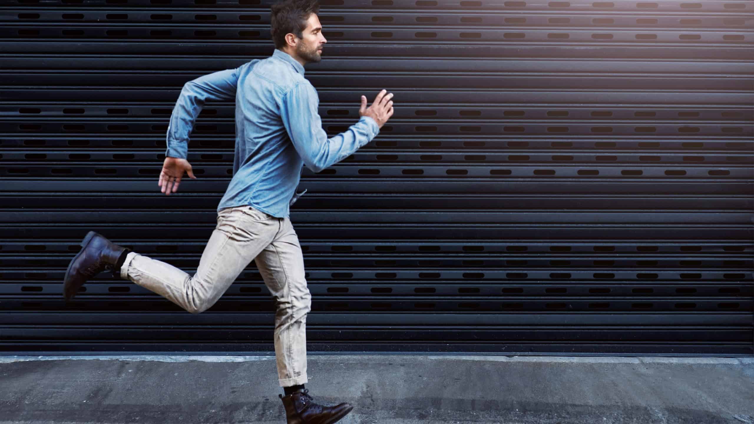 Chase after your dreams. Shot of a handsome young man running in the city.