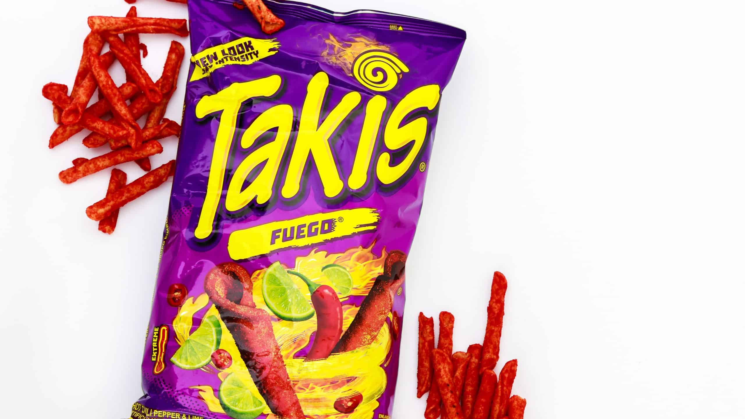 February 3, 2023. Spartanburg, SC USA. Rolling tortilla chips with chili peppers and lime by Takis Fuego