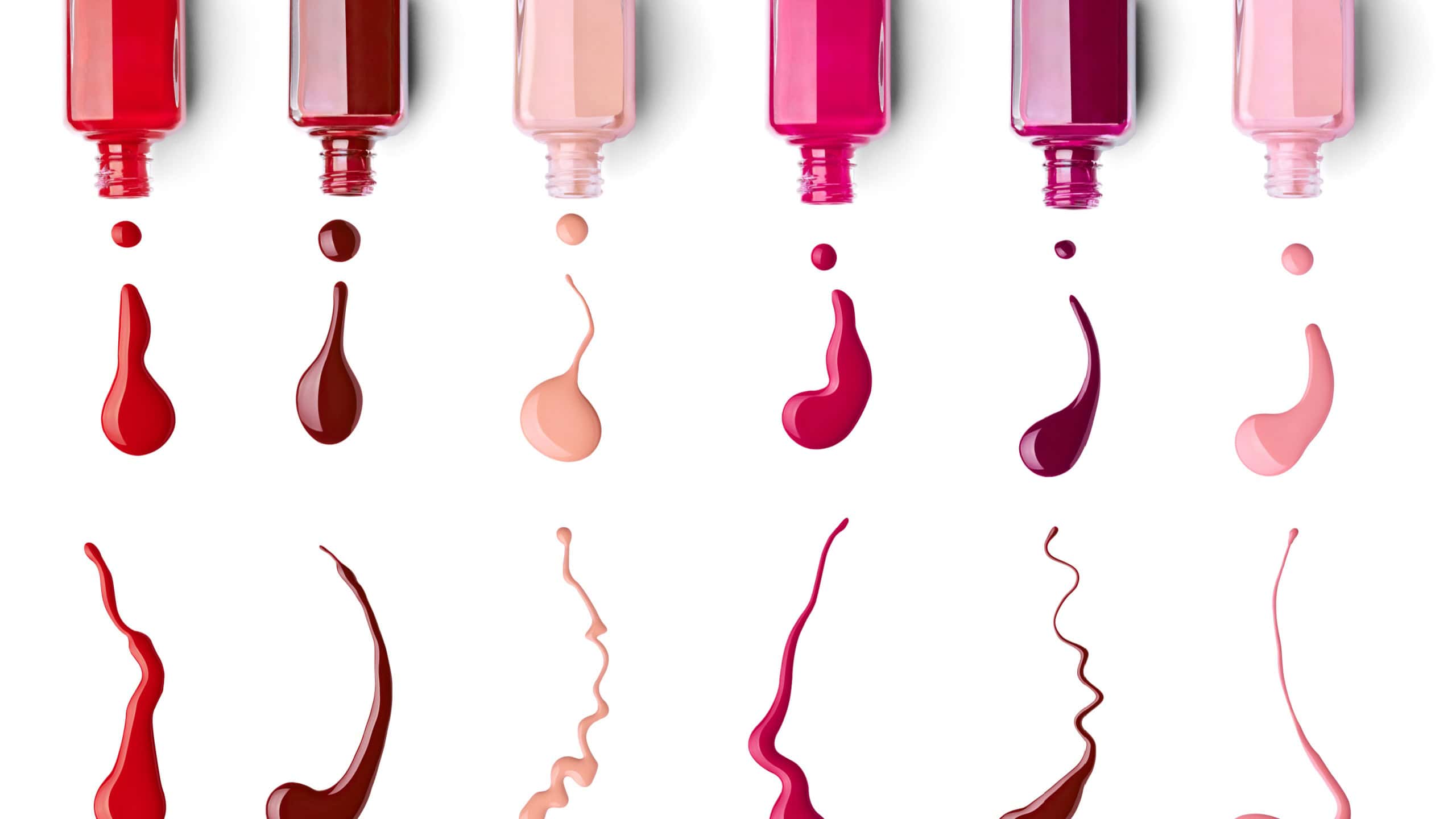 collection of various nail polish bottle and drop on white background. each one is shotseparately