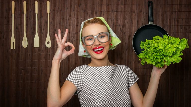 Happy woman cook with okay sign holding salad, close up