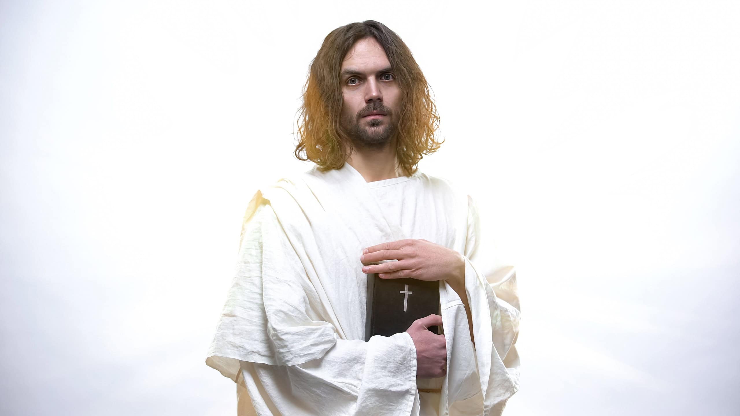 God Jesus holding Holy Bible, prophecies for Christians, new testament book