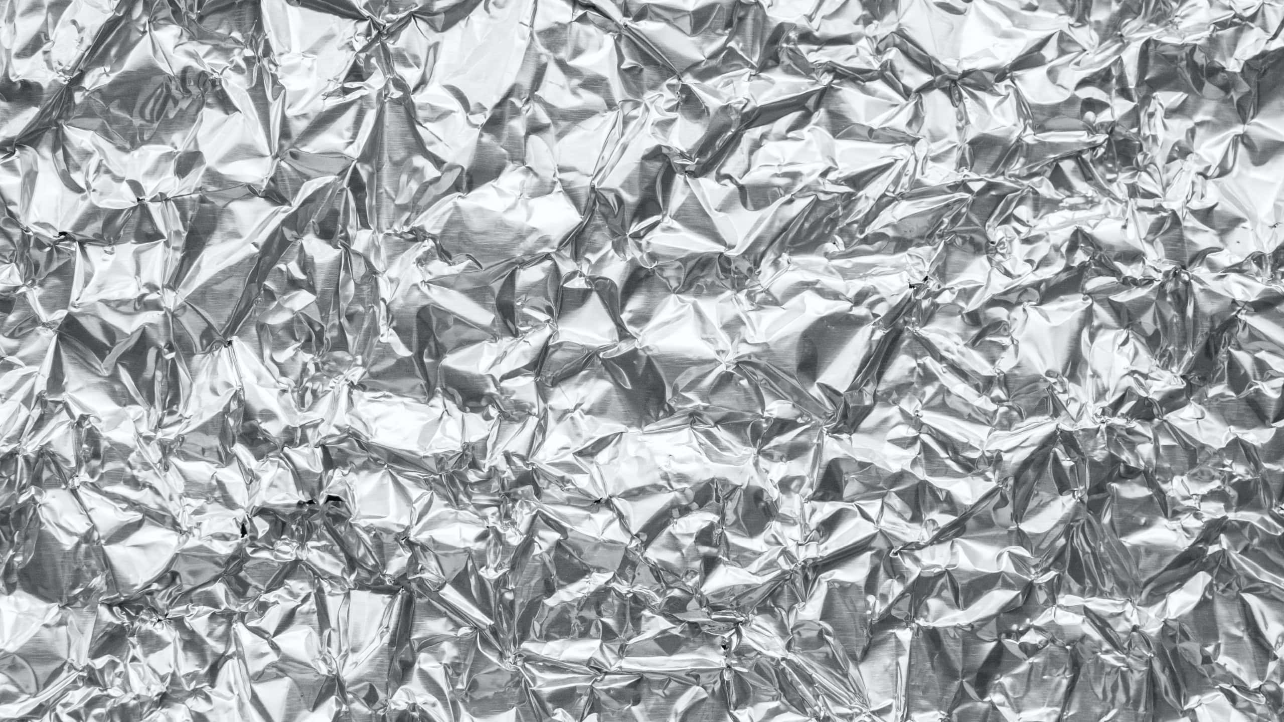 Shiny metal silver gray foil crumpled texture background