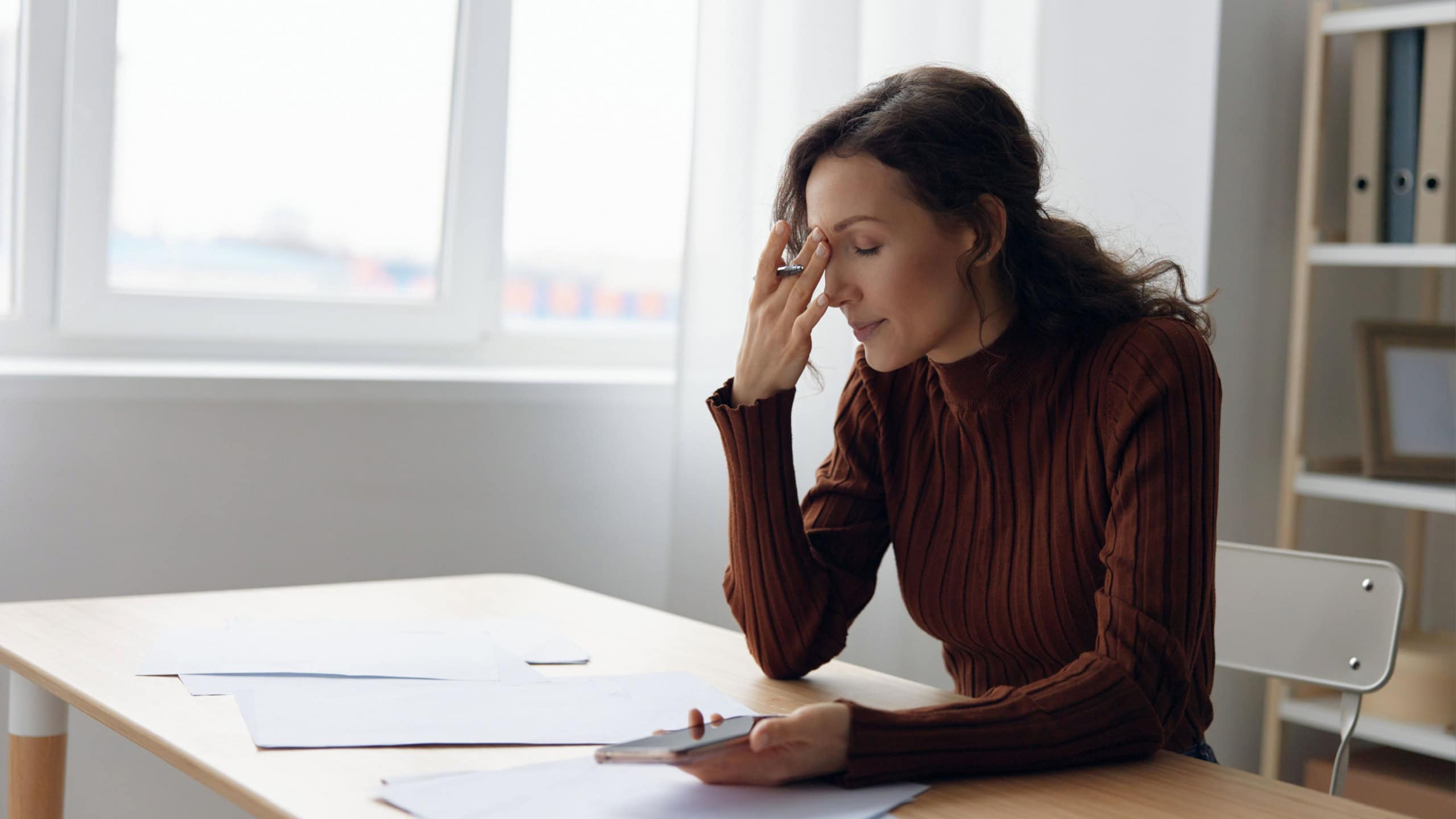 Upset unhappy suffering sad frustrated curly adorable woman doing facepalm touch forehead have serious financial problems bad relationships troubles at work worried about debt notification. Copy space