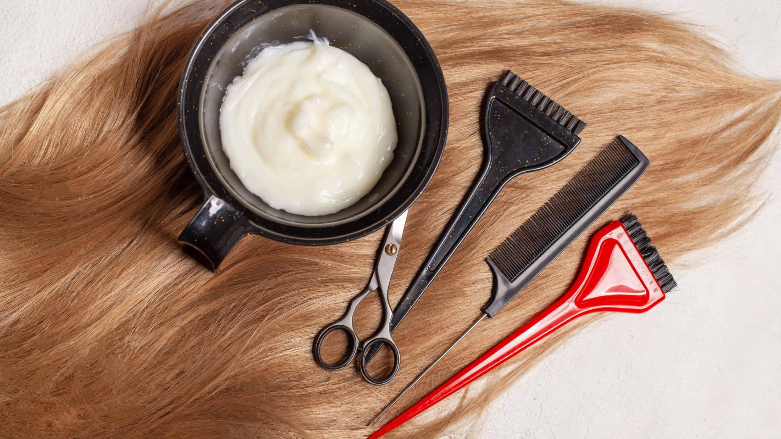 Top view of hair, scissors, comb and hair dye, beauty hair salon concept
