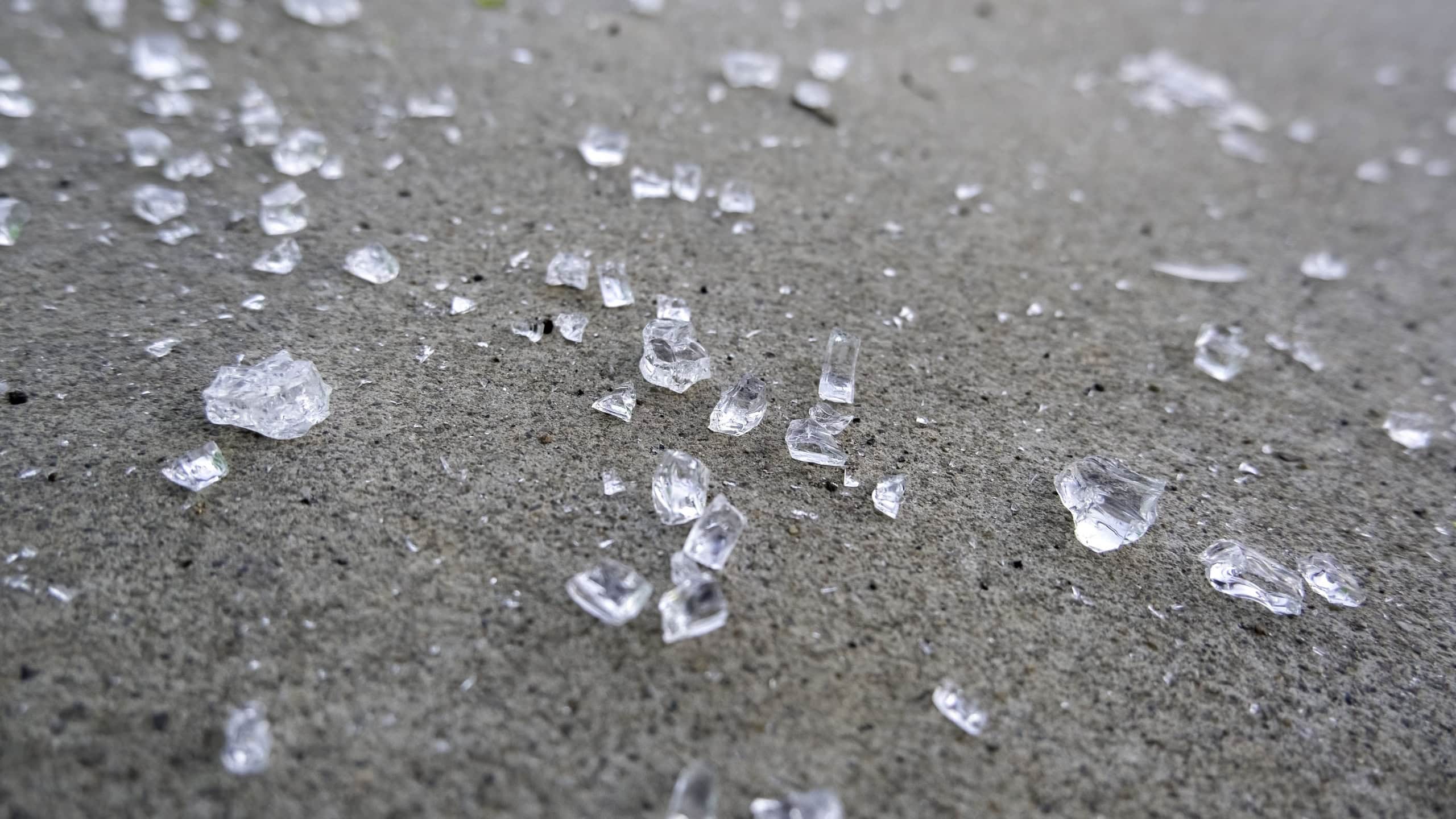 Broken glass on ground, danger and vandalism