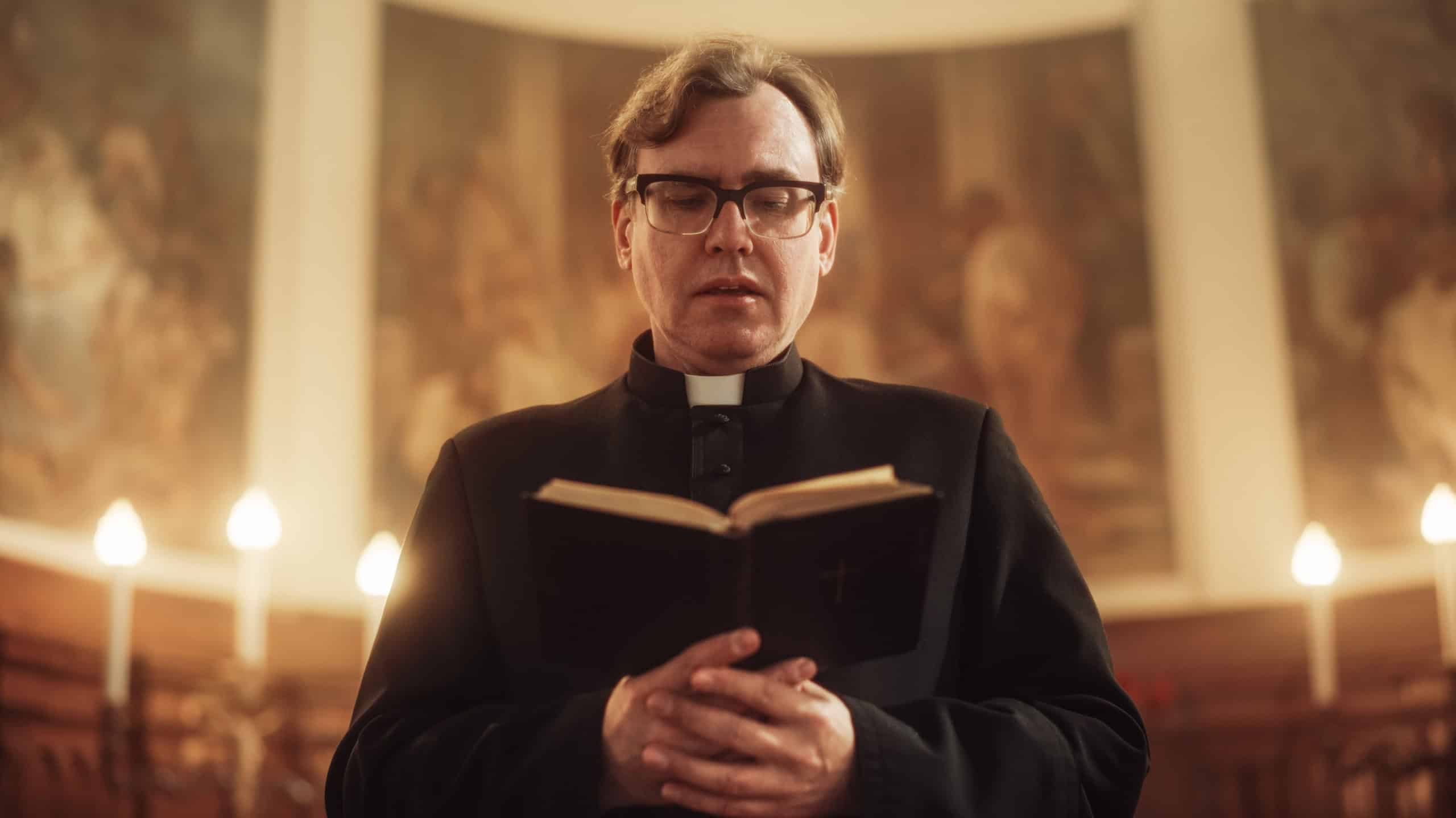 In Christian Church: The Minister Leads The Congregation In Prayer and Reads From The Holy Book, The Bible, Gospel of Jesus. Portrait of Priest Providing Guidance, Belief, Hope, Solace to People