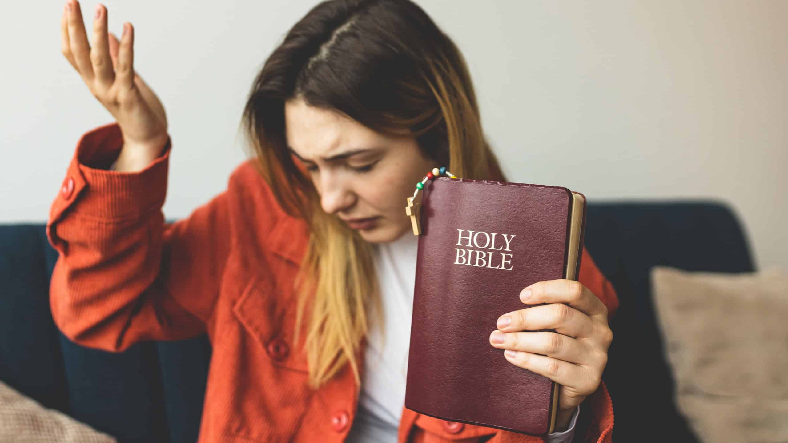 A woman is holding a Bible and praying. Studying the Holy Scriptures. Spiritual growth. Faith and spirituality. Bible study and prayer. Oration.