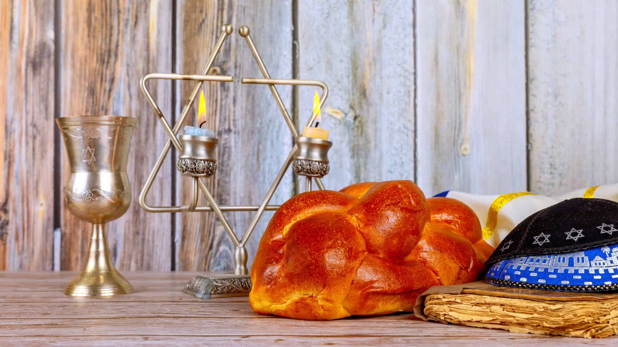 Sabbath Jewish Holiday celebration traditional homemade hallah bread kosher wine and candles on table.