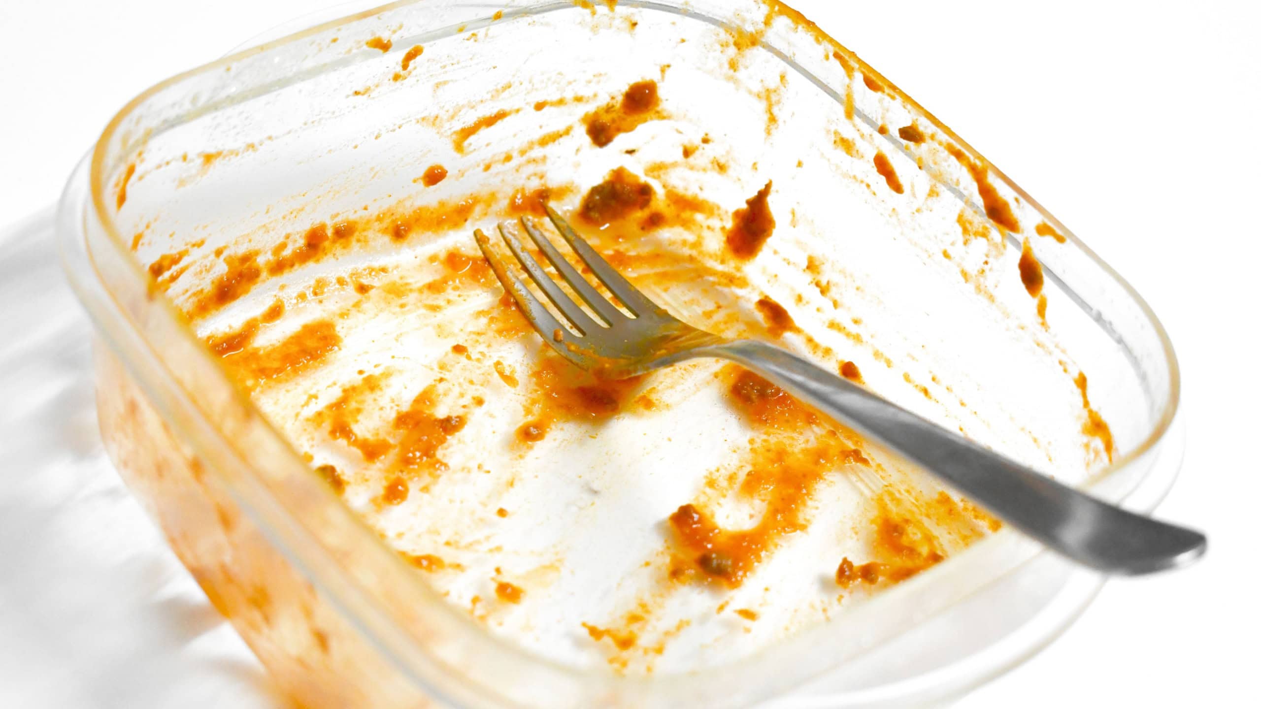 Dirty food plastic box and fork . Unclean dishes.