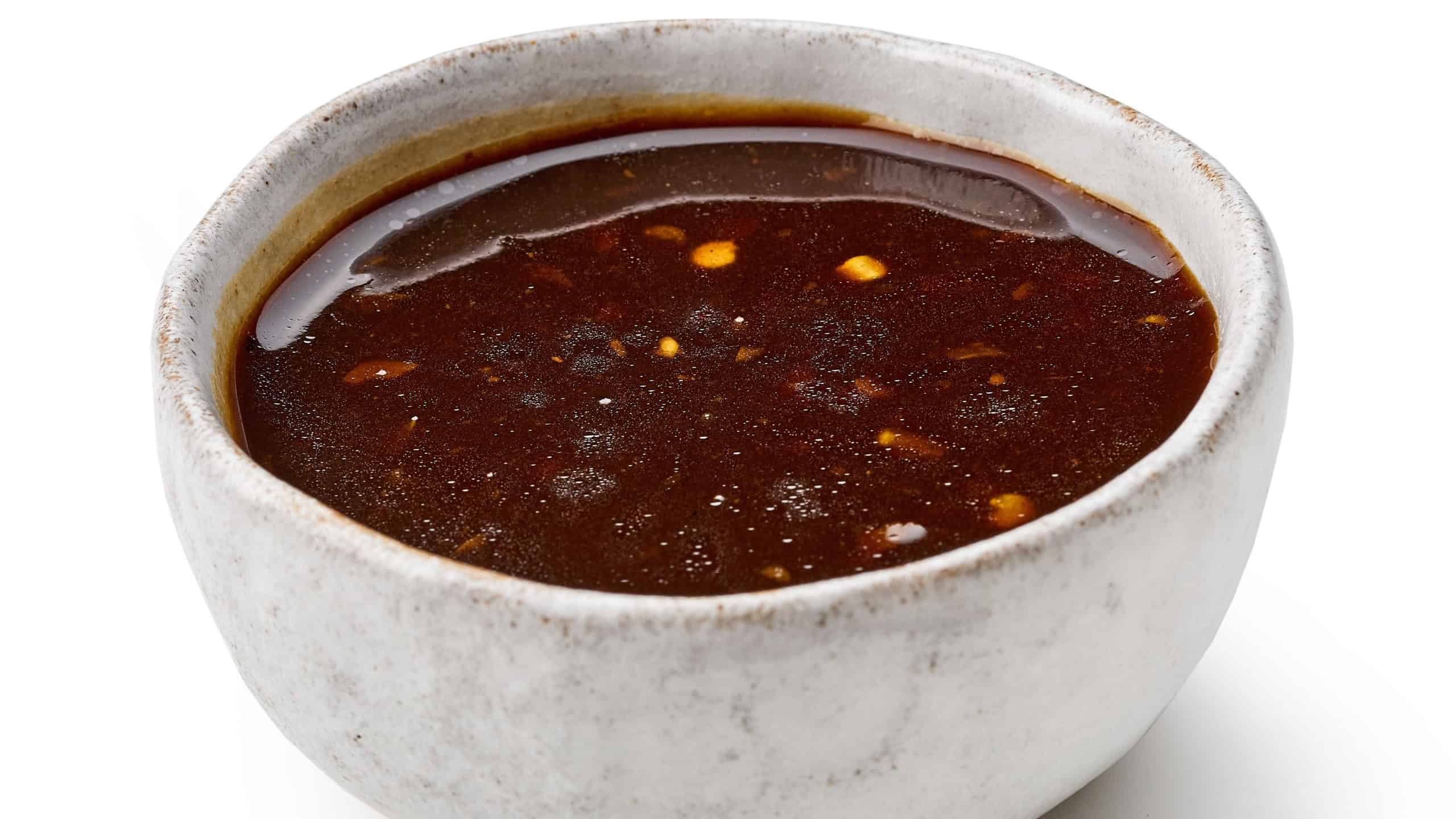 bowl of chinese asian barbecue garlic brown sauce isolated on white background