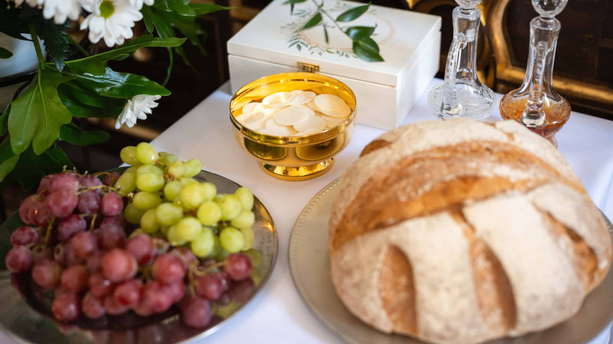 Traditional gifts of the altar on the day of the First Holy Communion: wafer, bread, grapes, water and wine in Poland