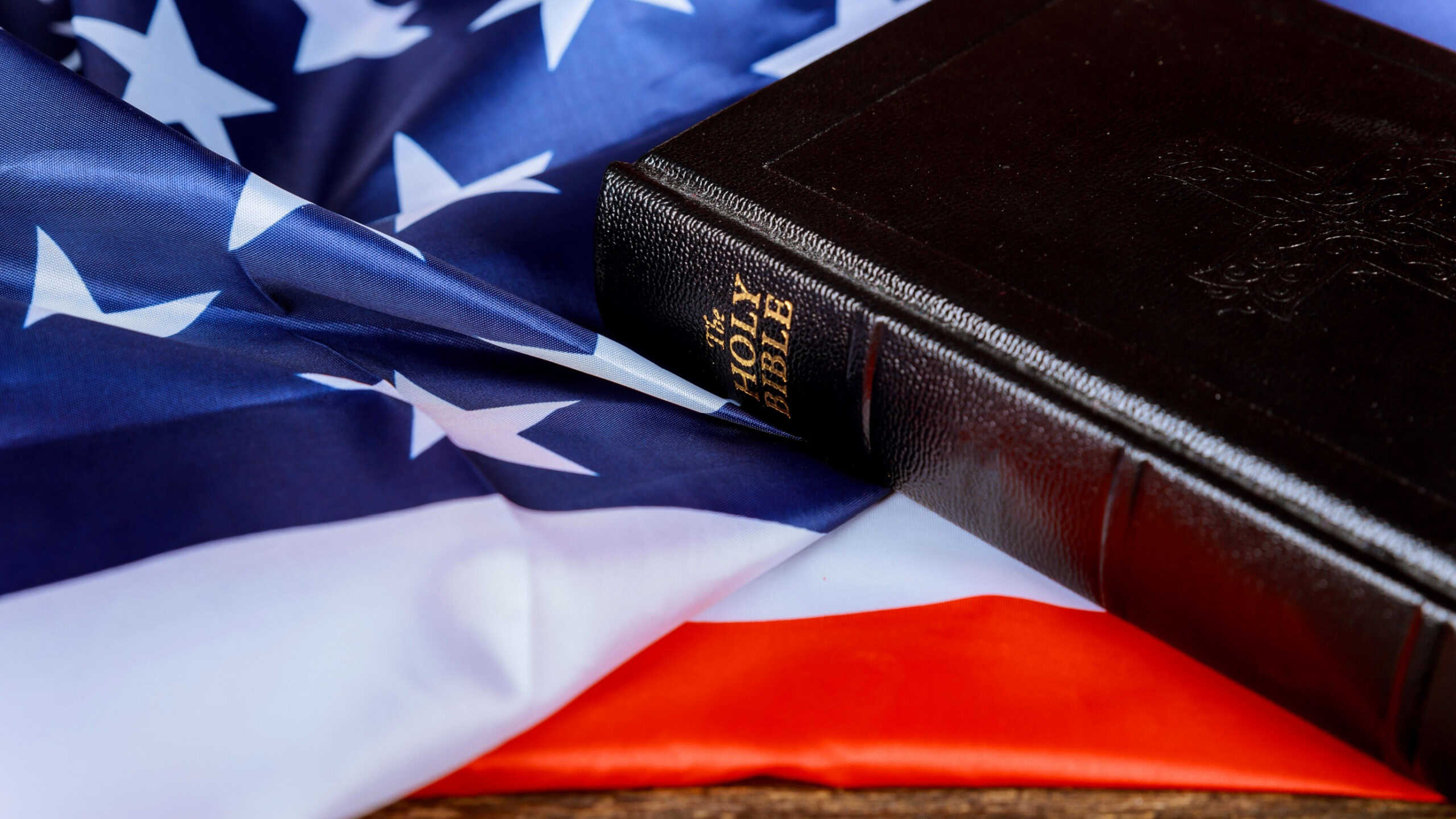United States Flag and Bible on Distressed Wood Background
