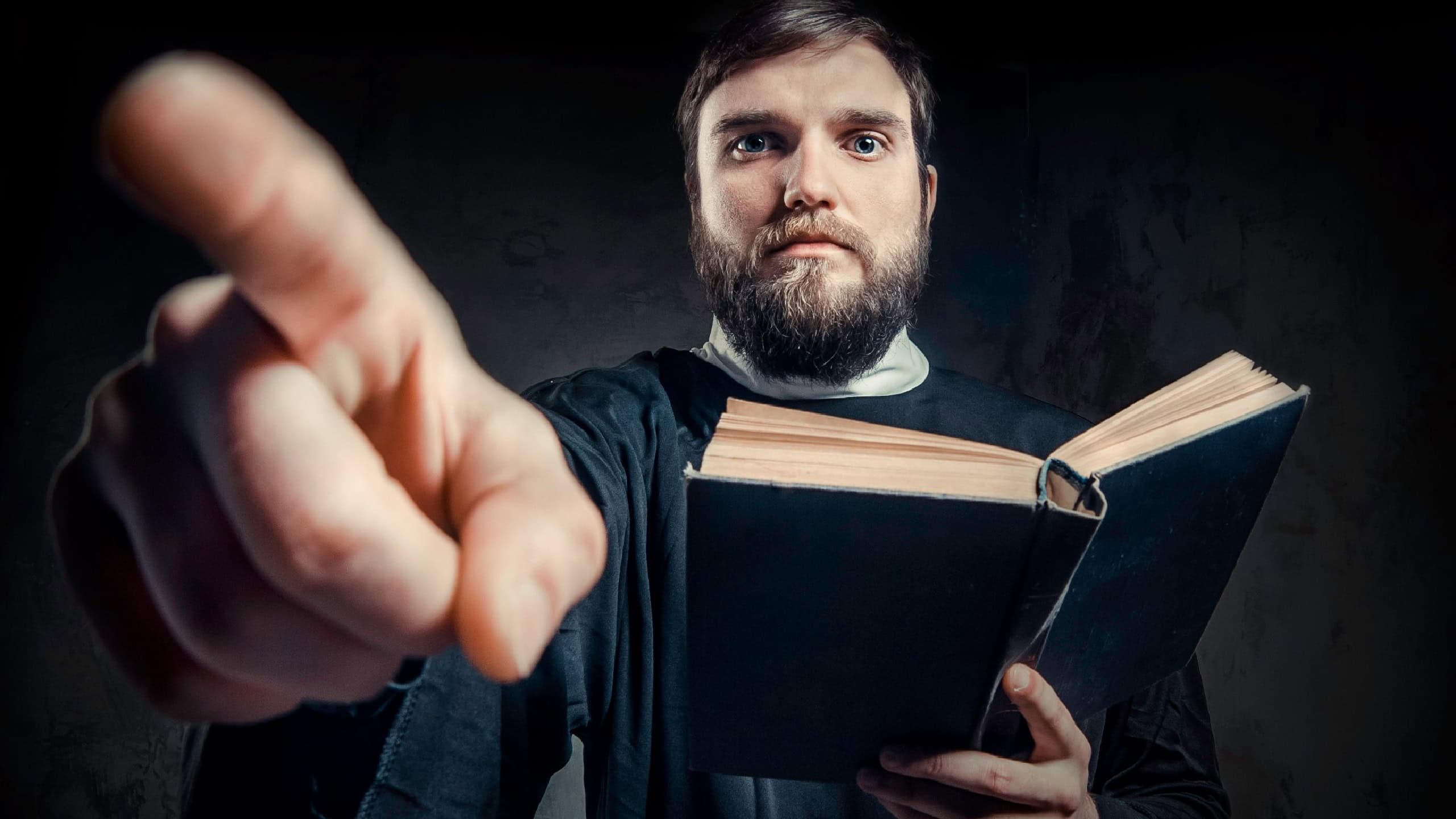 Priest with Prayer book against dark background