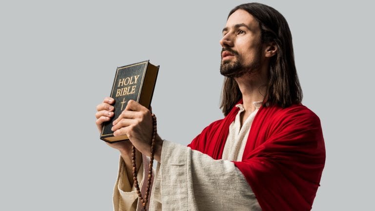 handsome jesus holding holy bible isolated on grey