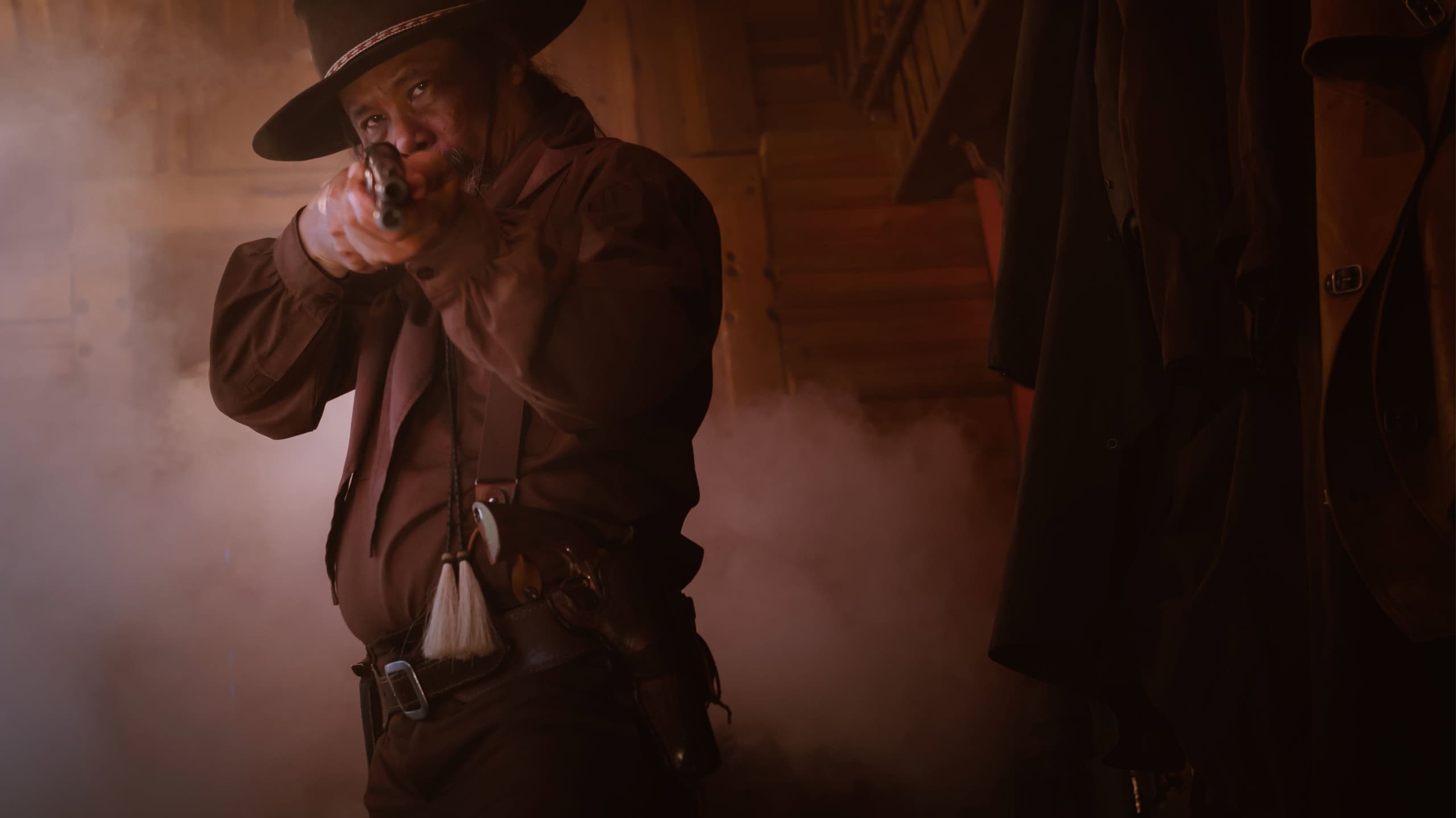 A cowboy posing with gun to shooting show protected weapon ,vintage style.