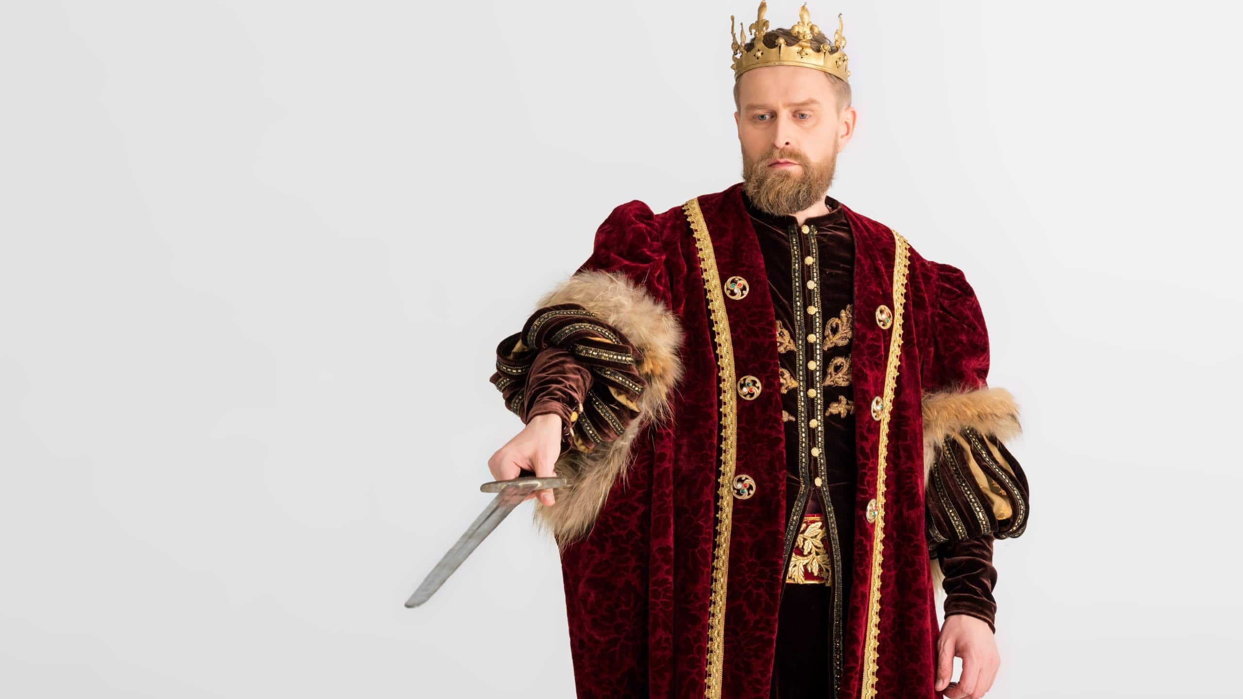 king with crown pointing with sword isolated on grey