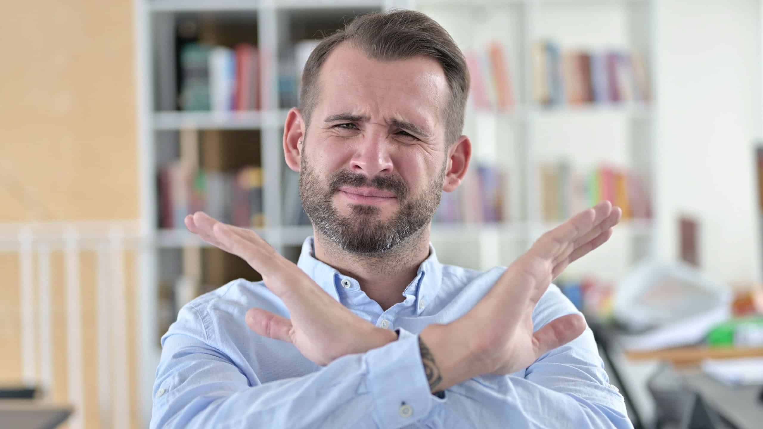 Portrait of Young Man with No Sign by Arm Gesture
