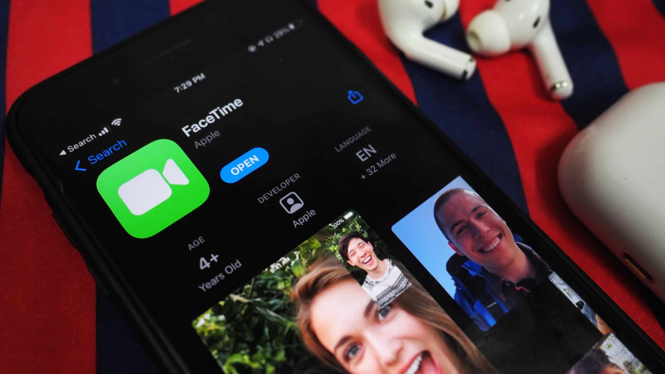 KOLKATA, INDIA - Aug 02, 2021: facetime app on app store opened in iPhone device on a table colorful background surface with airpods pro horizontal closeup top view