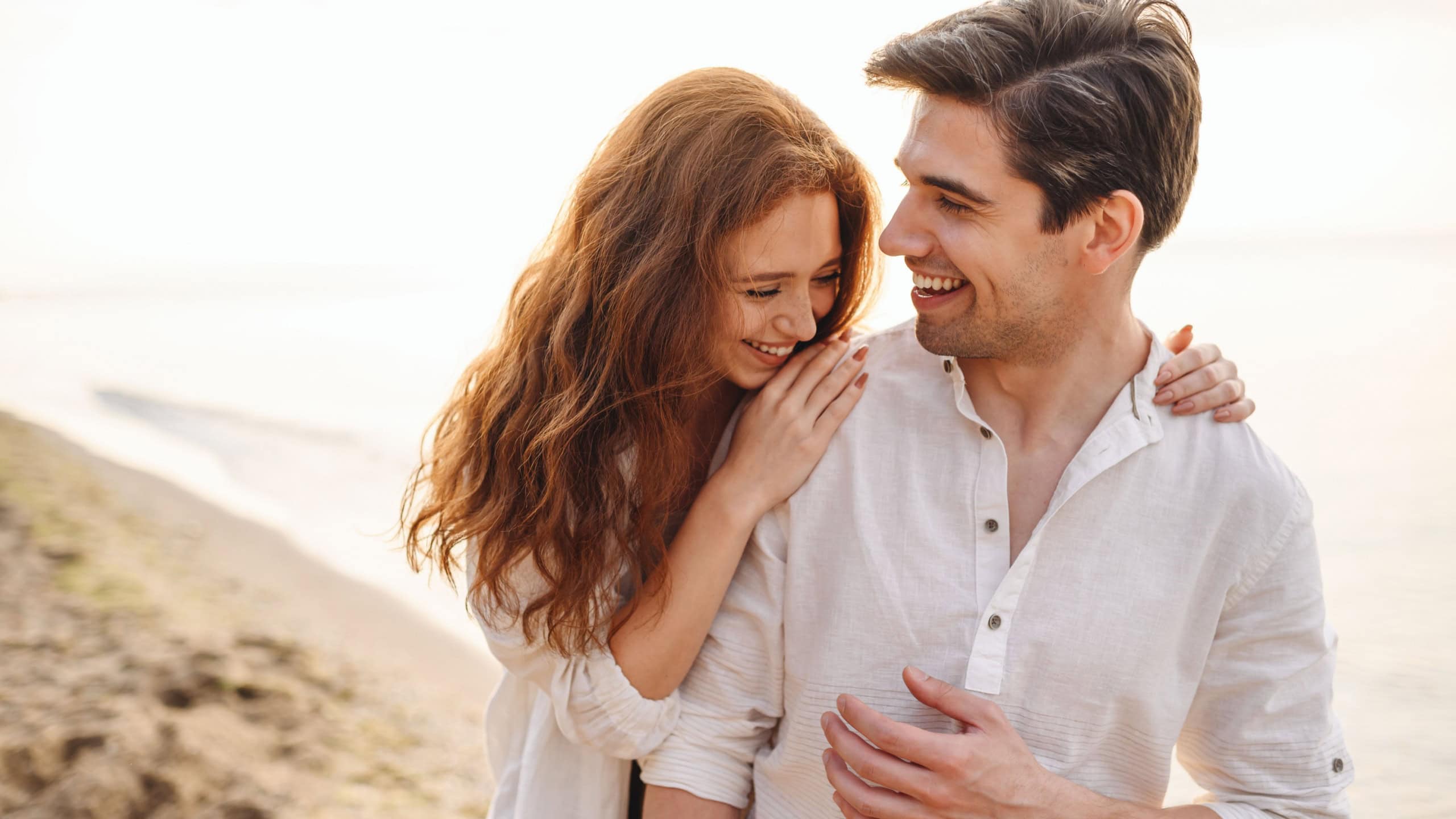 Happy fun young couple two friends family man woman in casual clothes hug girlfriend put head on boyfriend shoulder at sunrise over sea beach ocean outdoor exotic seaside in summer day sunset evening